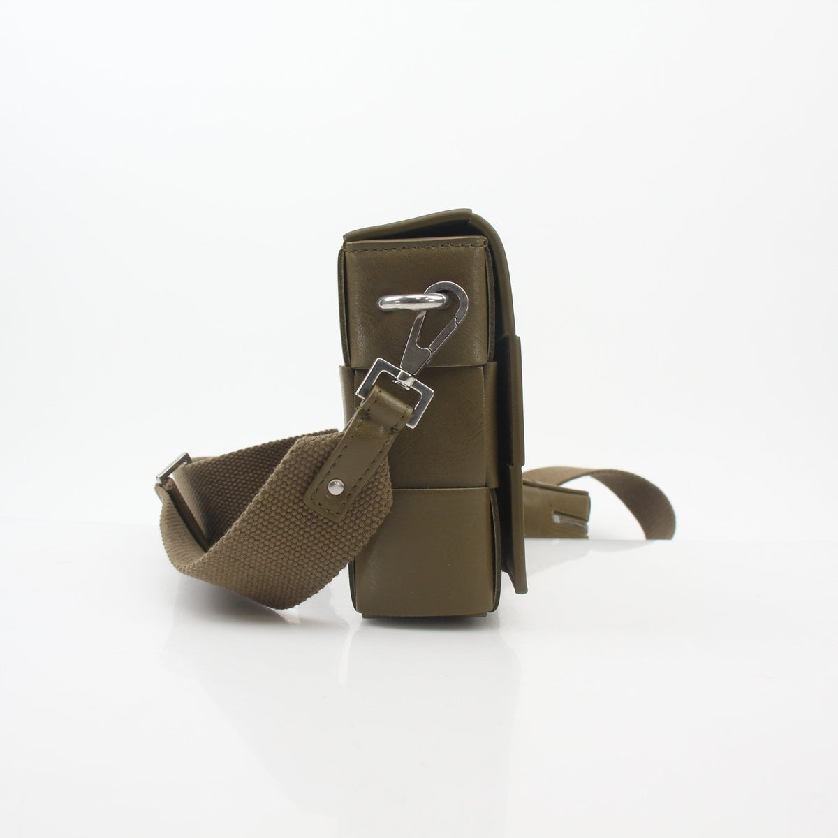 Olive green Bottega Veneta Cassette on Strap Crossbody Bag with gold chain detail, stylish handbag with woven leather texture.