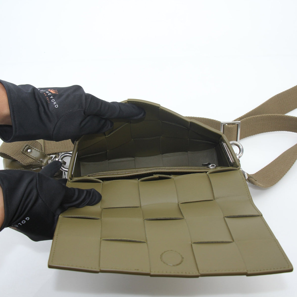 Olive green Bottega Veneta Cassette on Strap crossbody handbag with gold hardware, featuring textured leather and sleek design.