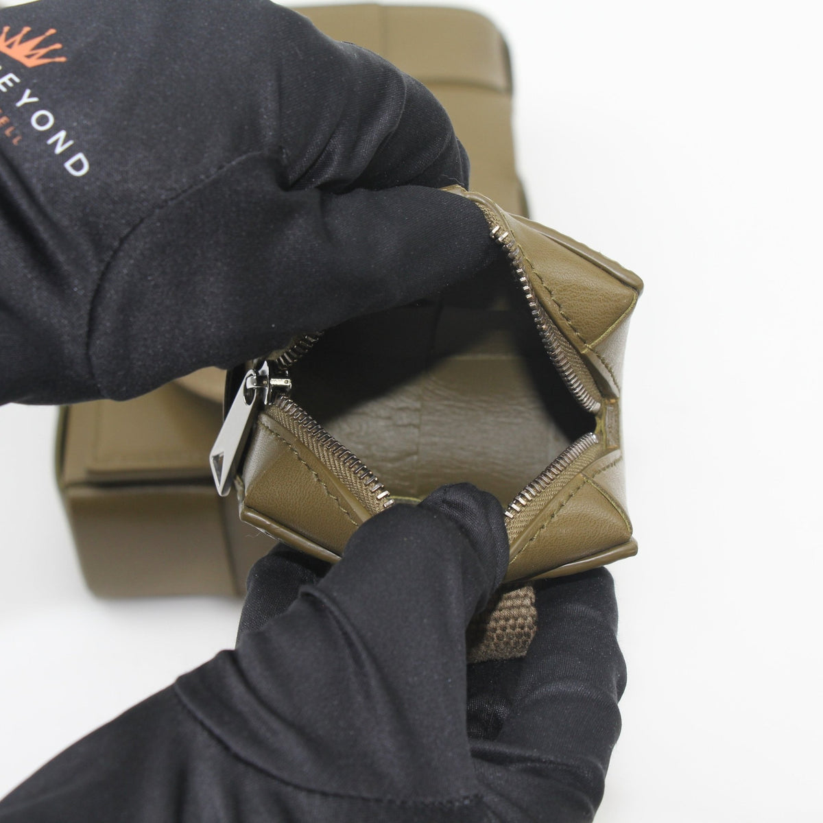 Olive green Bottega Veneta Cassette on Strap crossbody handbag with gold accents, featuring a sleek, textured leather design.