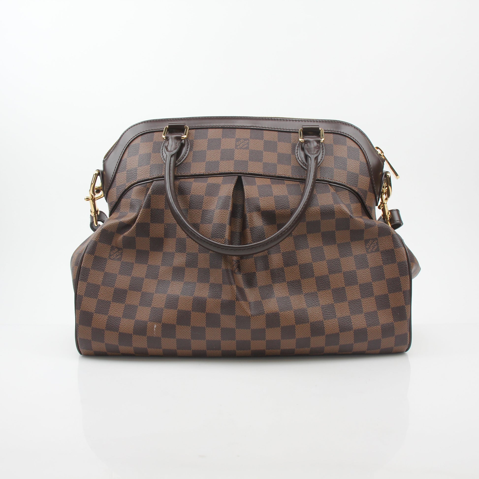 Louis Vuitton Damier Ebene Trevi GM handbag with leather handles and gold-tone hardware, showcasing classic checkerboard pattern.