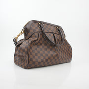 Louis Vuitton Damier Ebene Trevi GM handbag with gold hardware, featuring signature checkered pattern and leather handles.