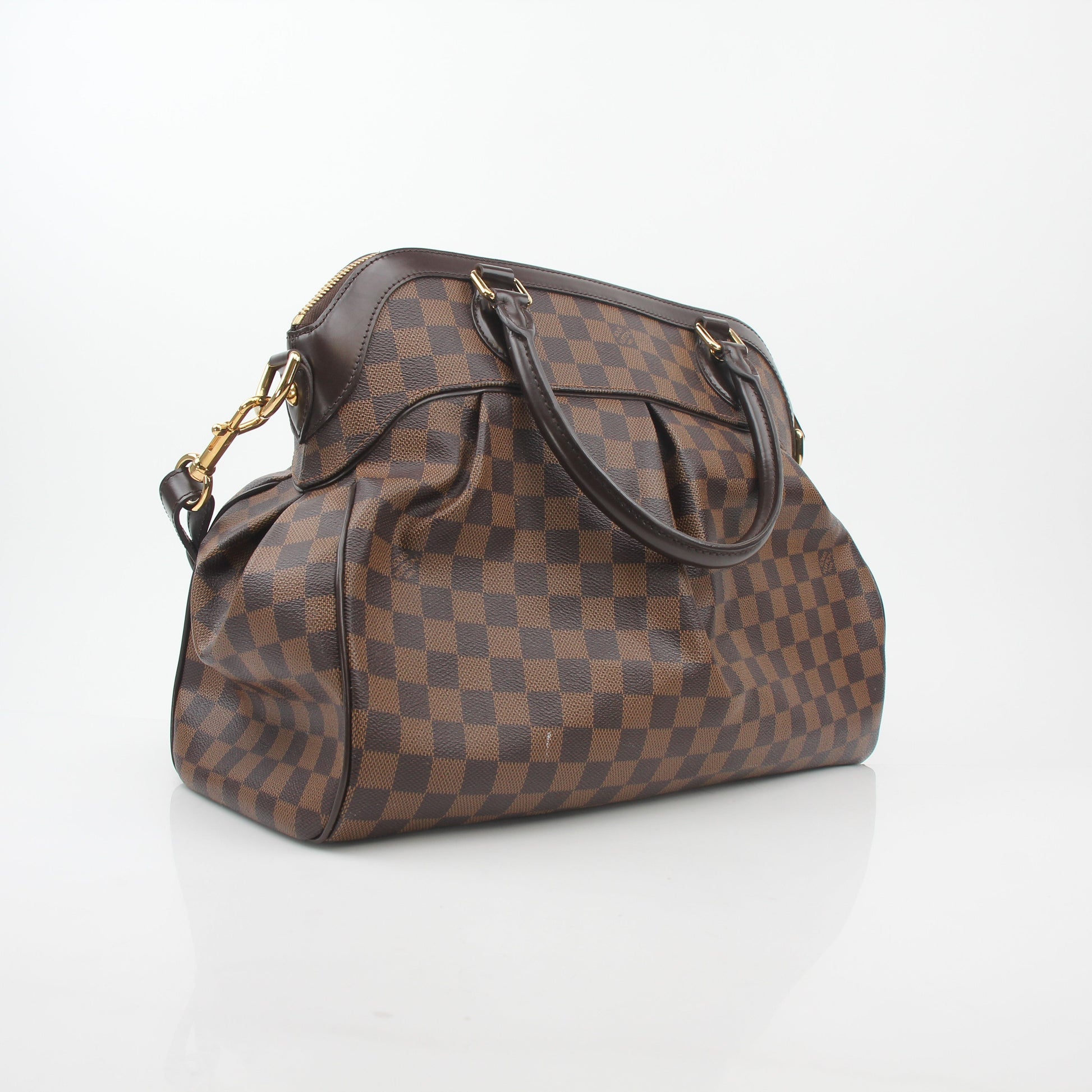 Louis Vuitton Damier Ebene Trevi GM handbag with gold hardware, featuring signature checkered pattern and leather handles.