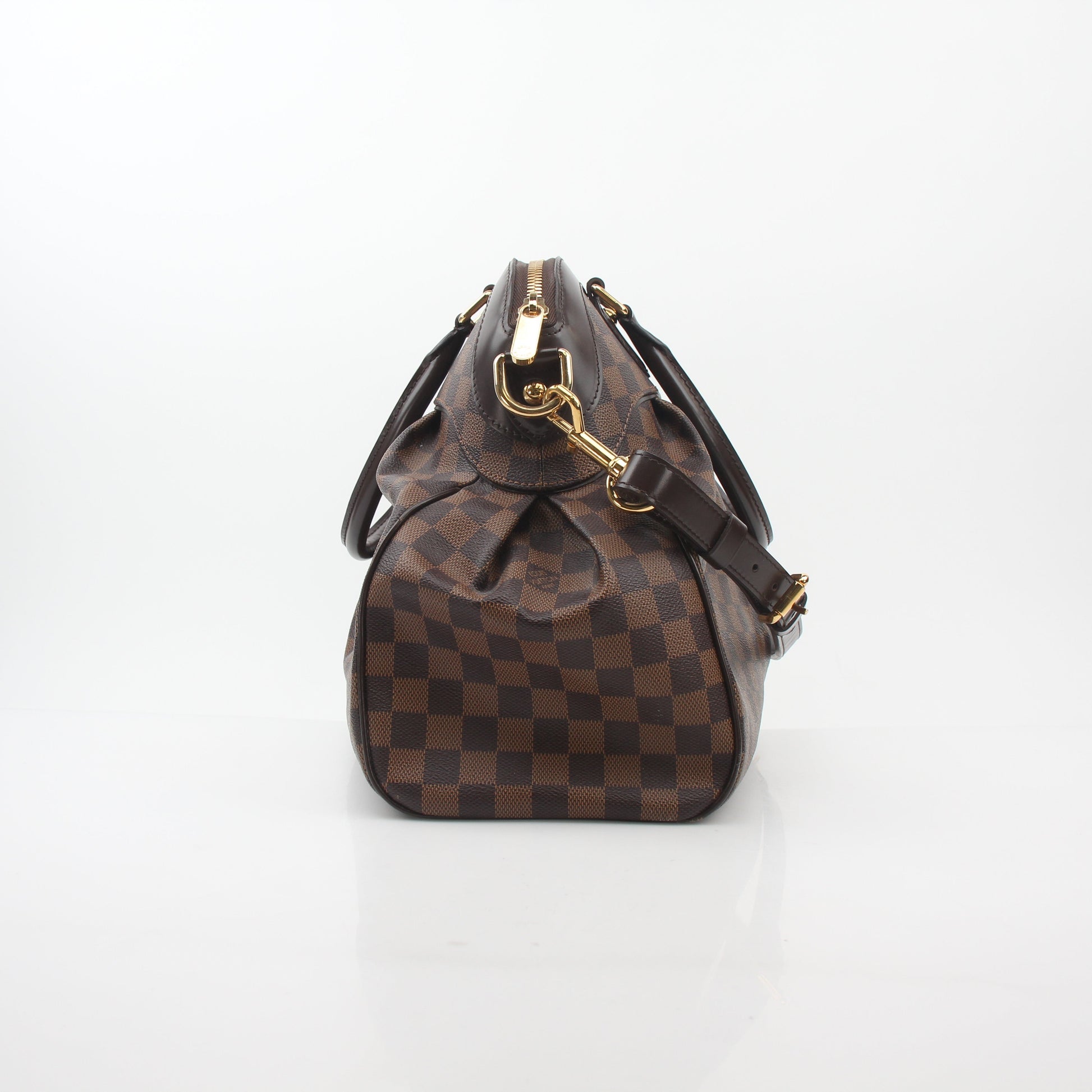 Louis Vuitton Damier Ebene Trevi GM handbag with leather handles and gold hardware, featuring a spacious interior.
