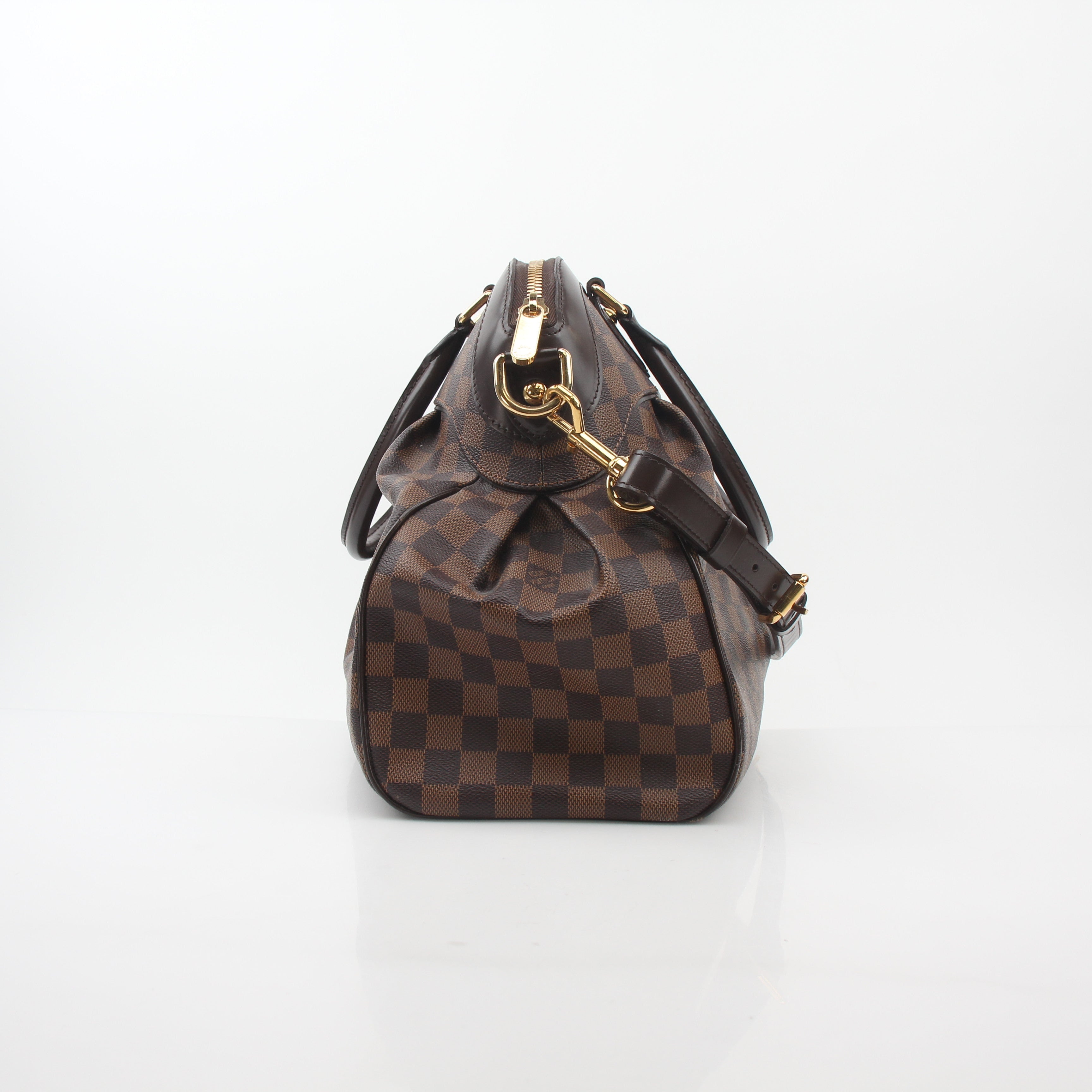 Louis Vuitton Damier Ebene Trevi GM handbag with leather handles and gold hardware, featuring a spacious interior.