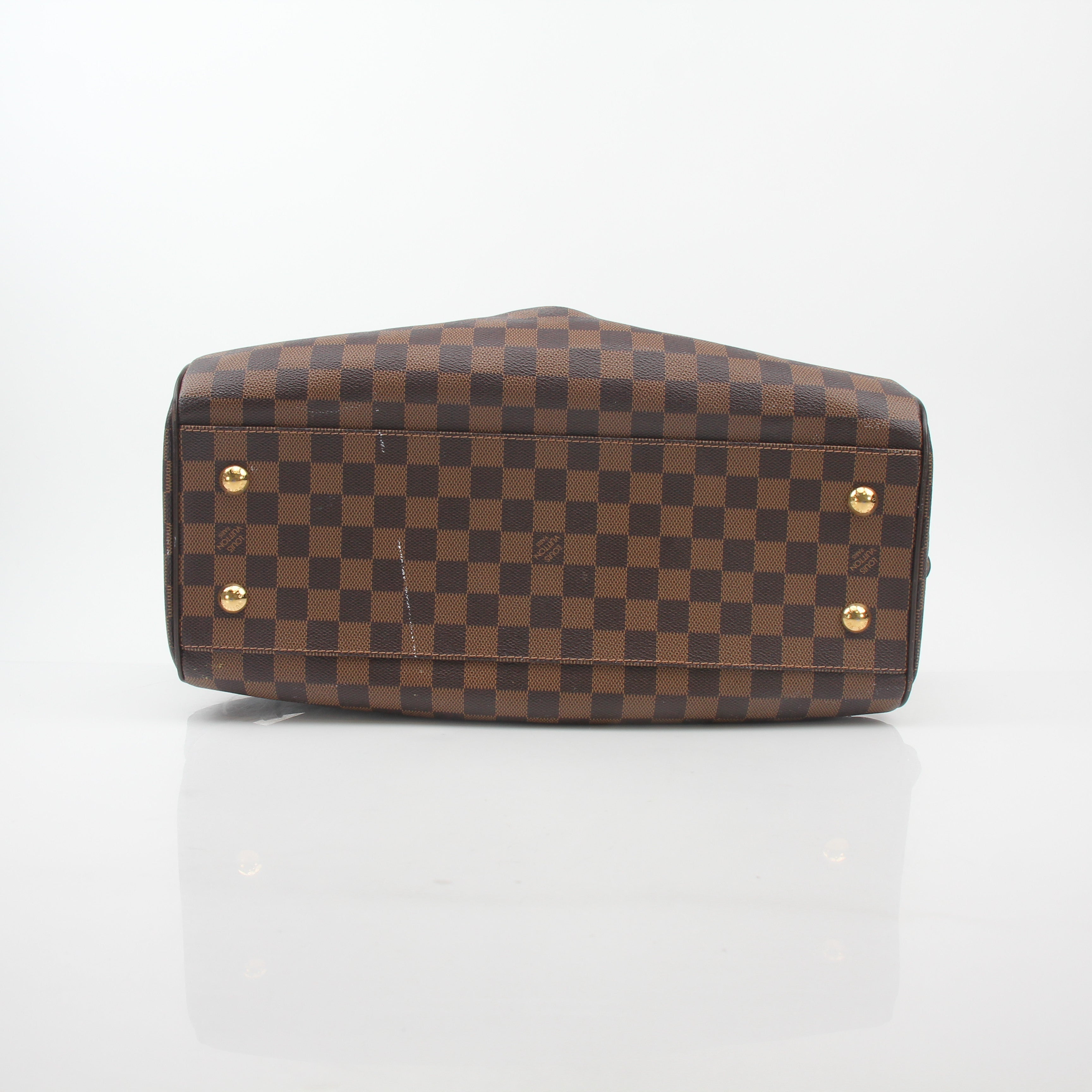 Louis Vuitton Damier Ebene Trevi GM handbag with gold hardware and leather handles, detailed fabric pattern, and spacious interior.