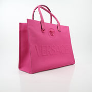 Pink Versace La Medusa embossed canvas tote handbag with gold-tone handles and logo details, stylish and spacious for everyday use.