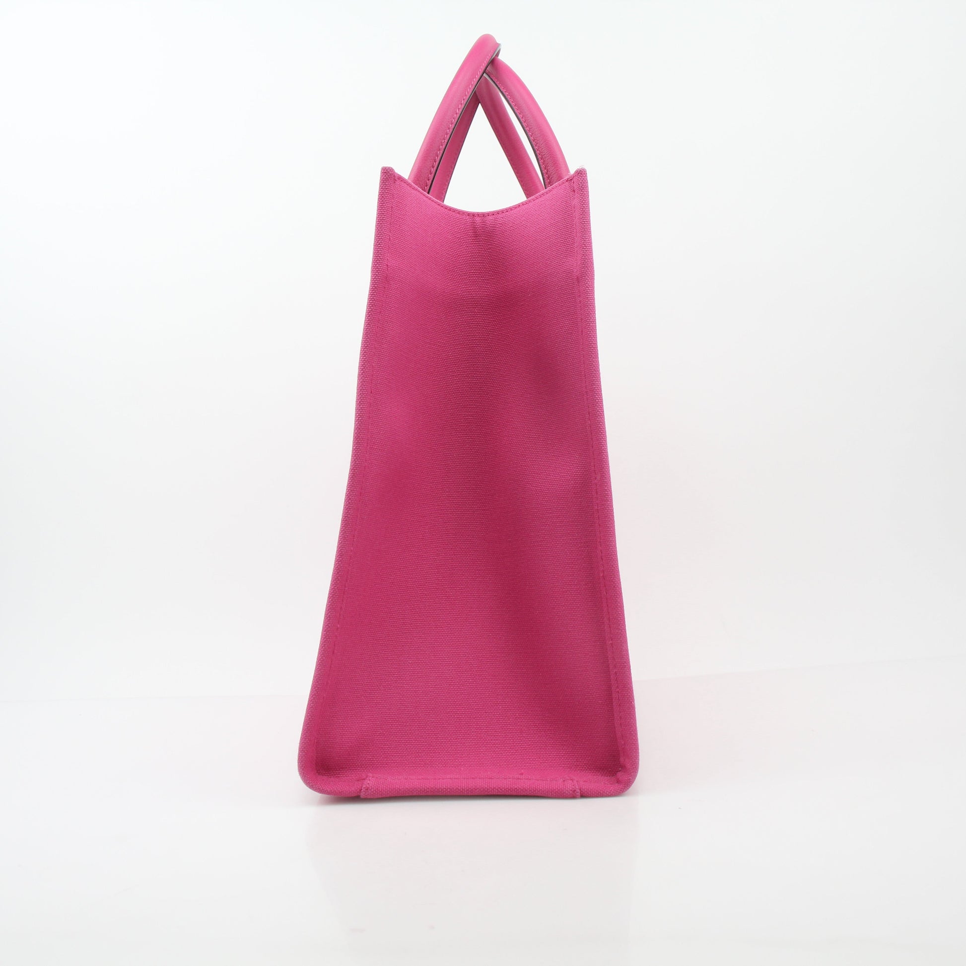 Pink Versace La Medusa embossed canvas tote handbag with gold accents, featuring a spacious design and logo detailing.