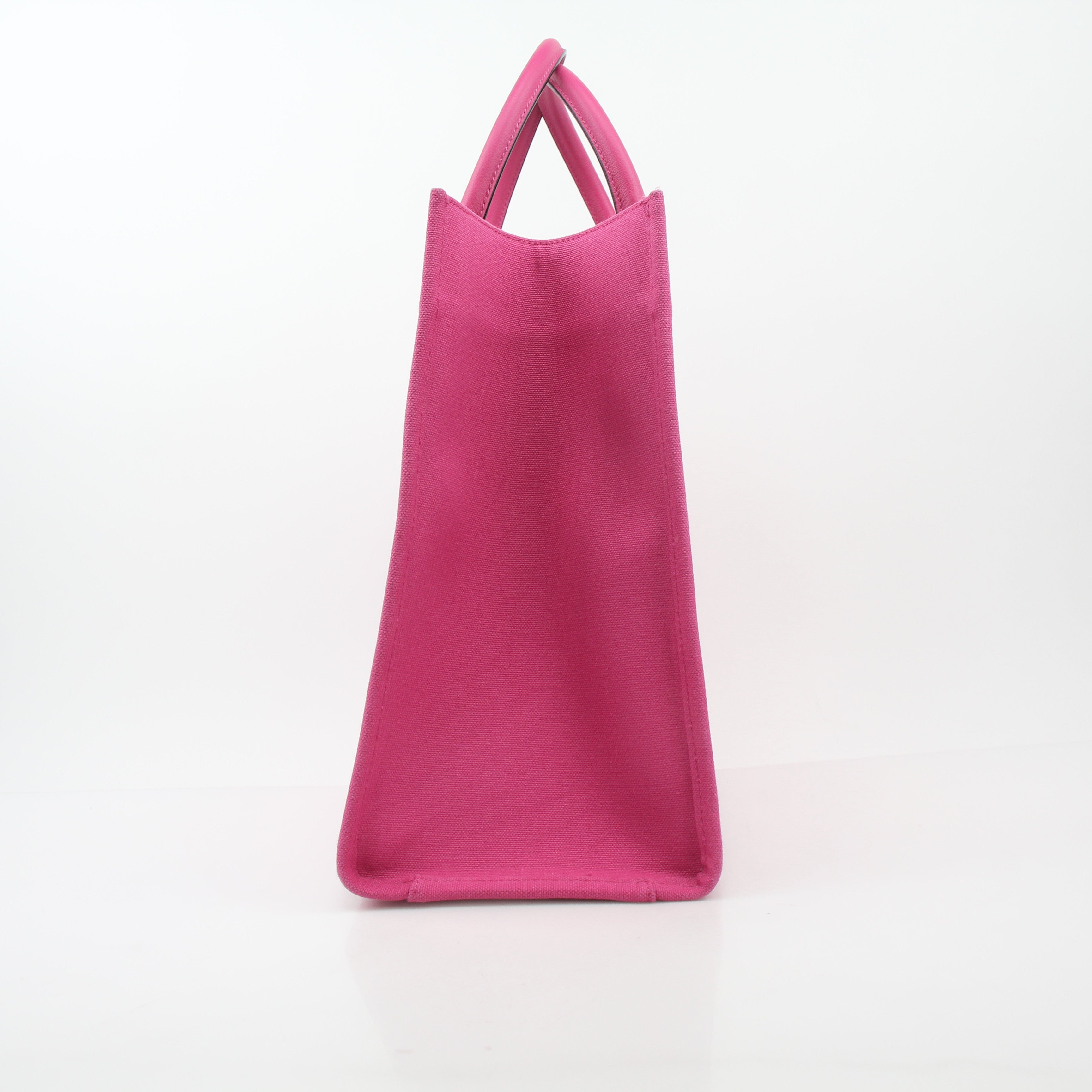 Pink Versace La Medusa embossed canvas tote handbag with gold accents, featuring a spacious design and logo detailing.