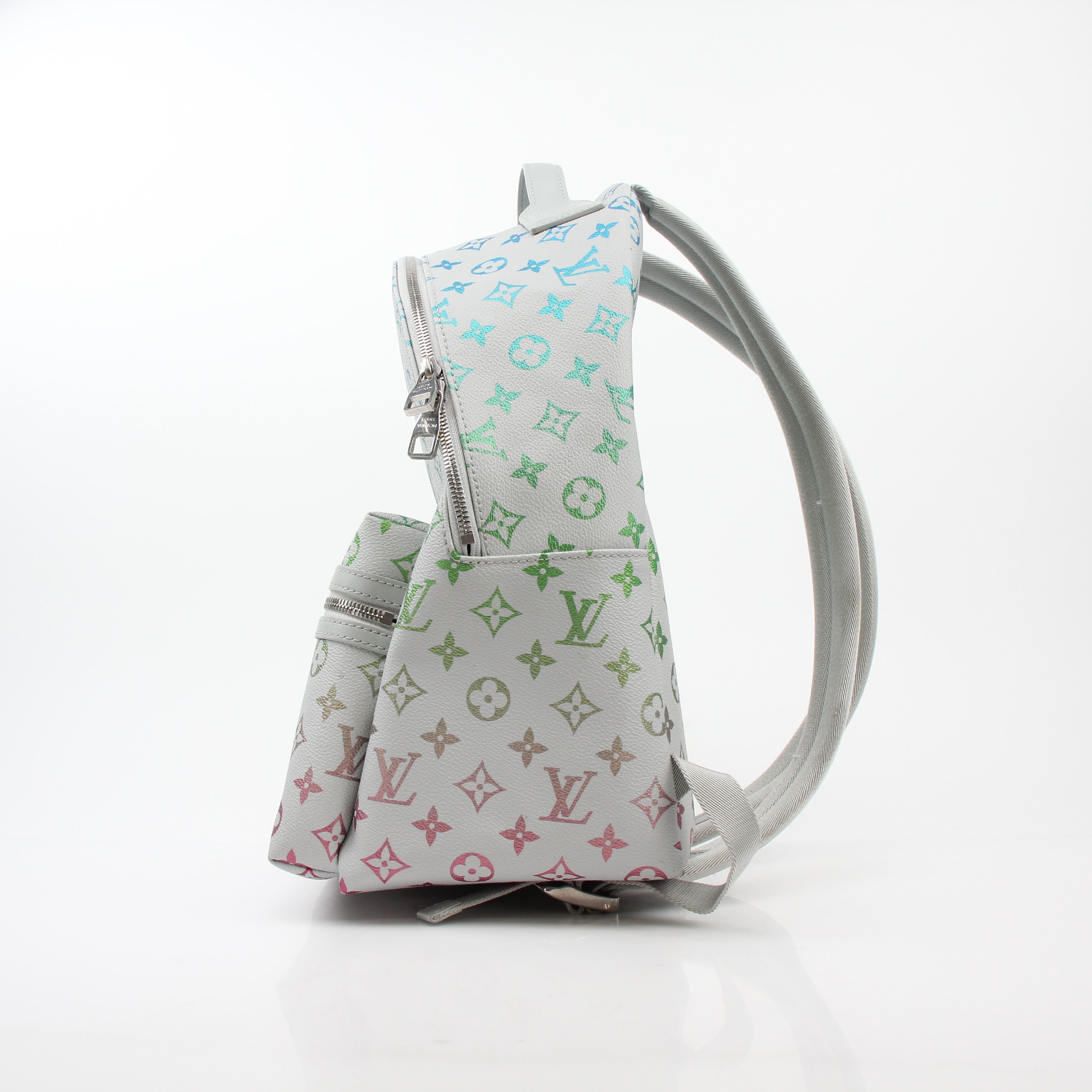 Louis Vuitton Iridescent Monogram Discovery Backpack PM, luxury travel bag with shimmering monogram design and adjustable straps.