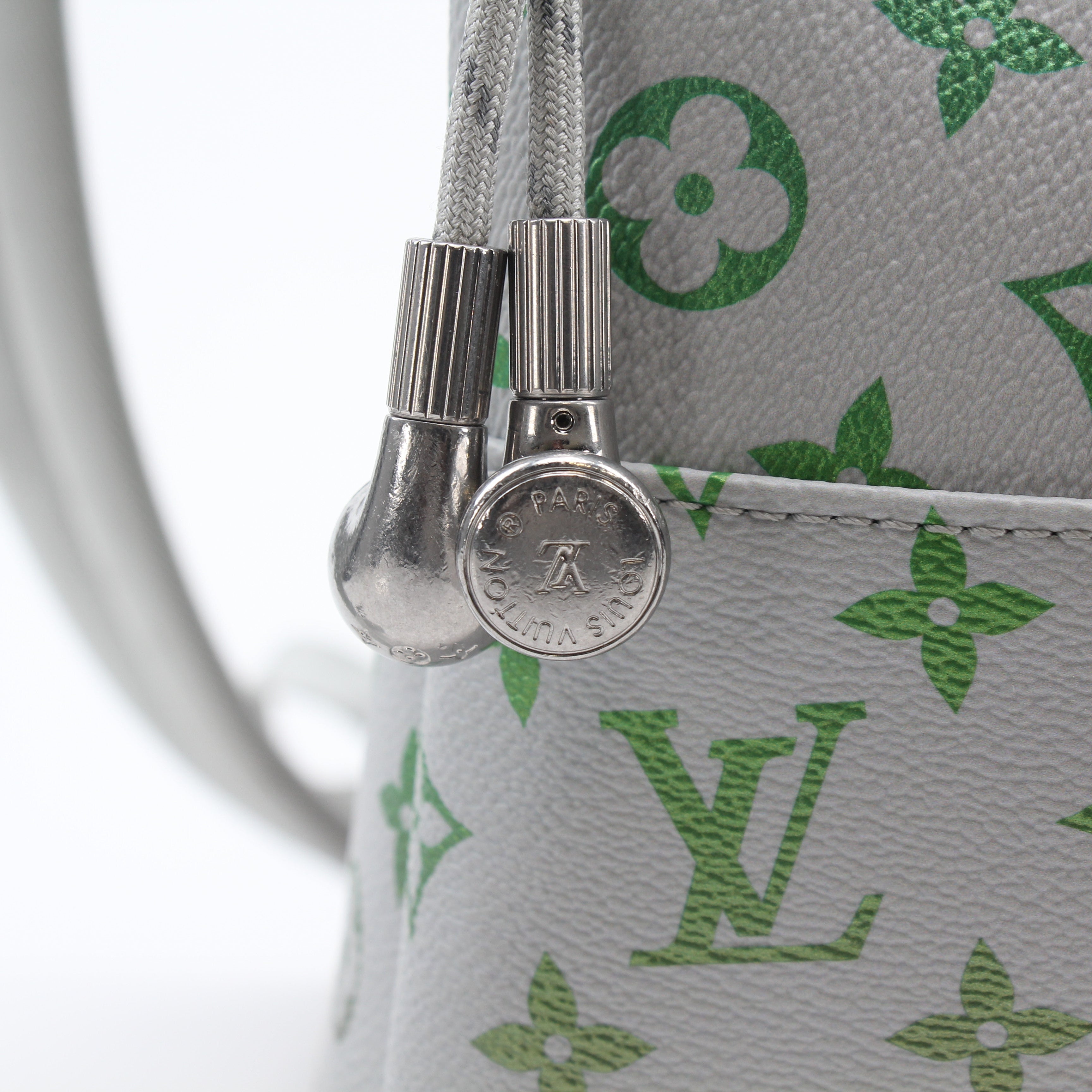 Louis Vuitton Iridescent Monogram Discovery Backpack PM, gold and purple travel bag with monogram pattern and adjustable straps.