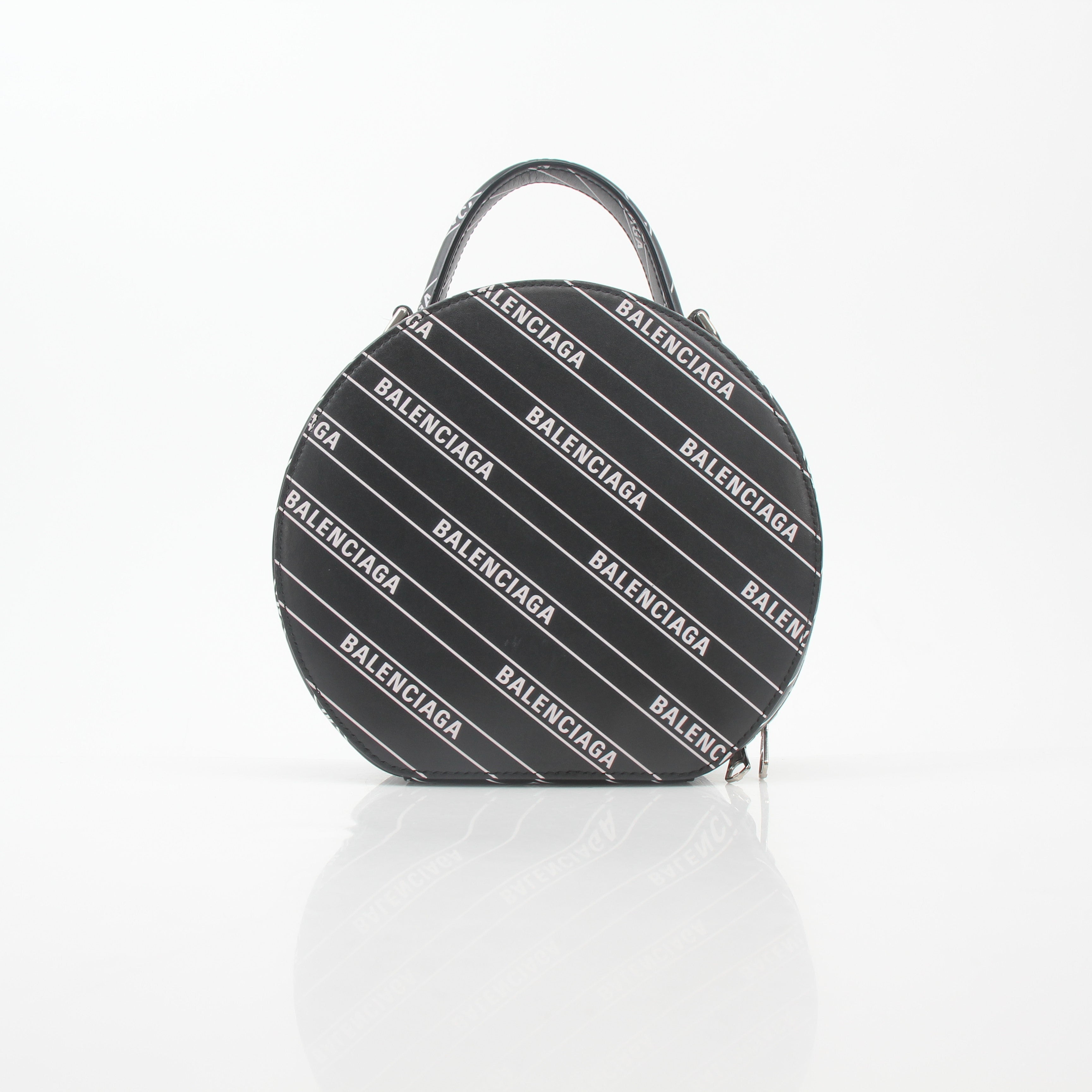 Black Balenciaga XS Vanity round handbag with logo detail, featuring a compact, stylish design in the image.