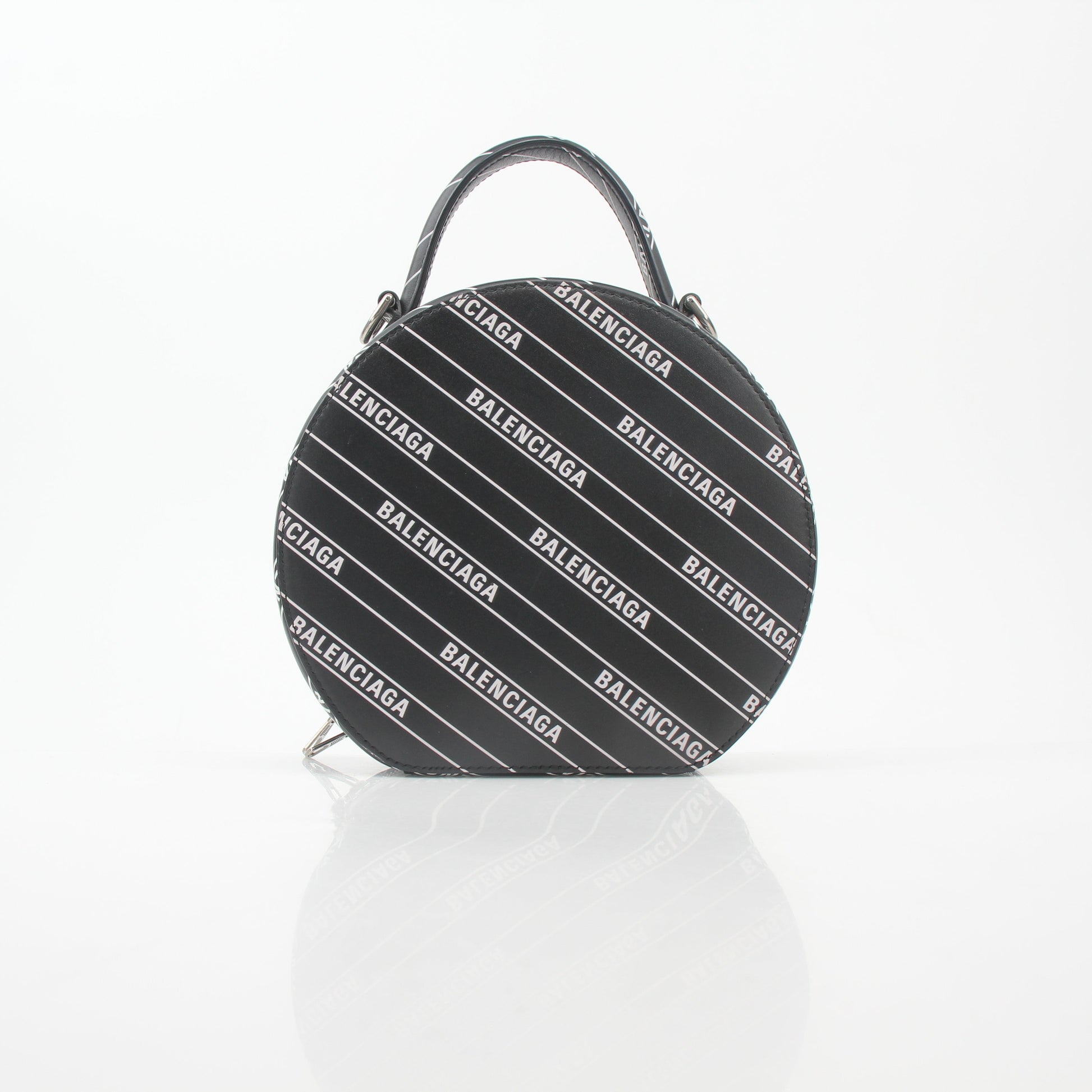 Black Balenciaga XS Vanity round handbag with logo detailing, featuring a compact, stylish design and gold accents.