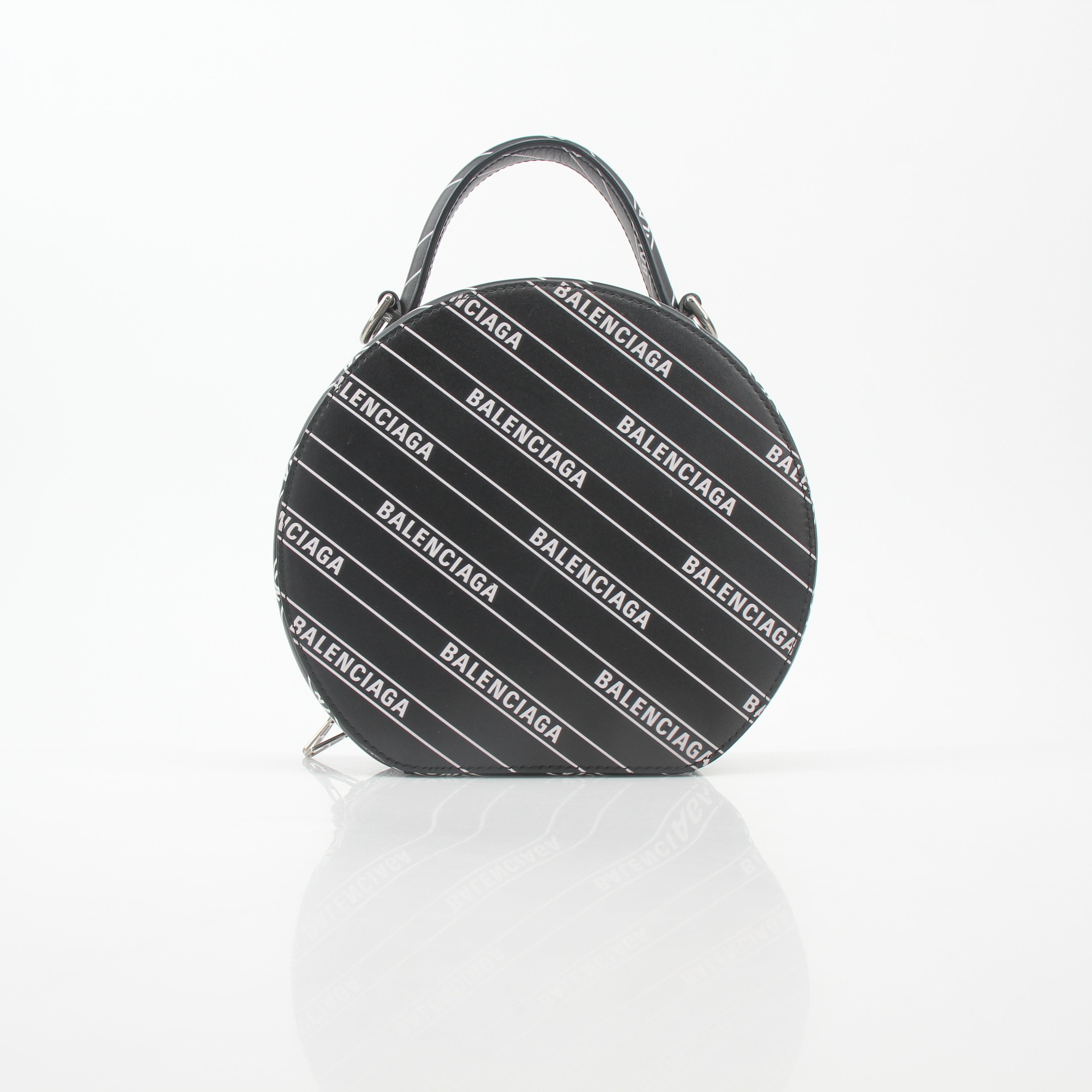 Black Balenciaga XS Vanity round handbag with logo detailing, featuring a compact, stylish design and gold accents.