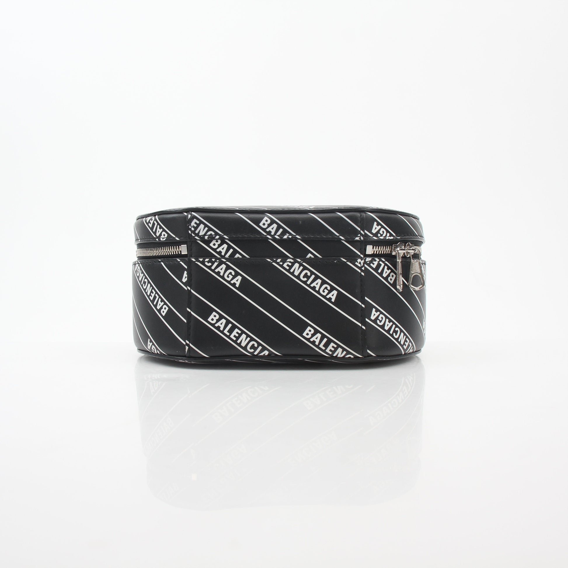 Black Balenciaga XS Vanity round handbag with logo design, featuring a compact, stylish leather purse with gold accents.