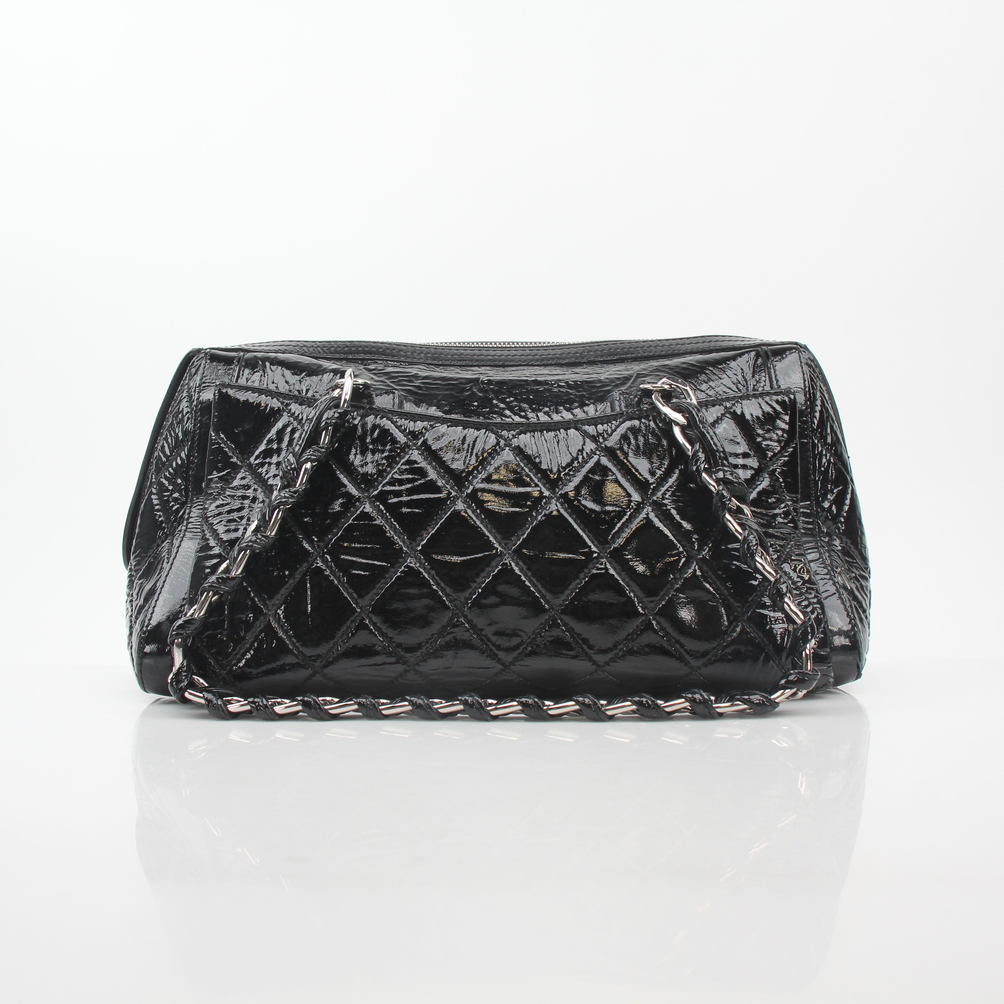 Gold & Beyond black quilted patent Chanel style handbag with glossy flap and gold chain strap.