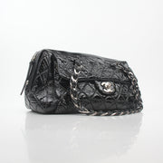Chanel black quilted patent Day Glossy Flap Bag with gold hardware, classic handbag design, and quilted pattern.