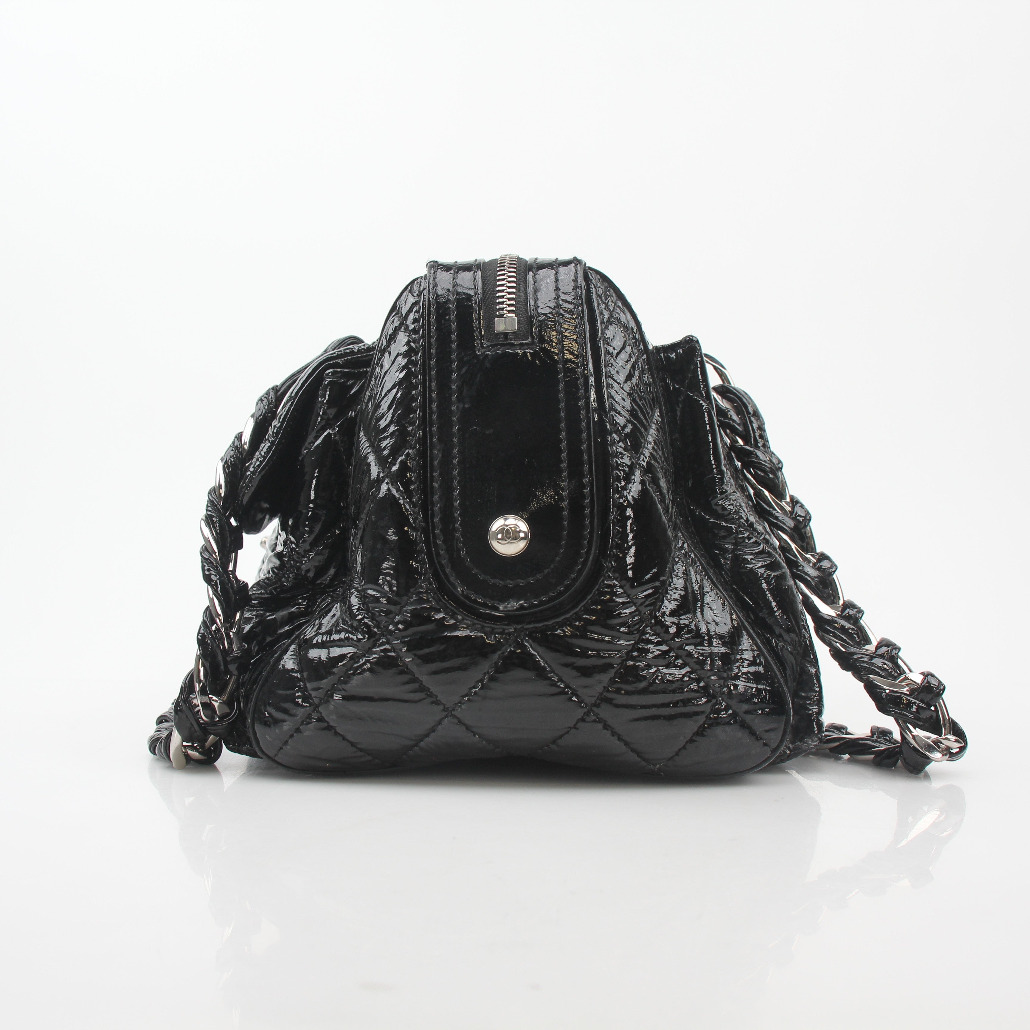 Gold & Beyond black quilted patent handbag with glossy flap and gold-tone chain strap, classic Chanel-inspired design.