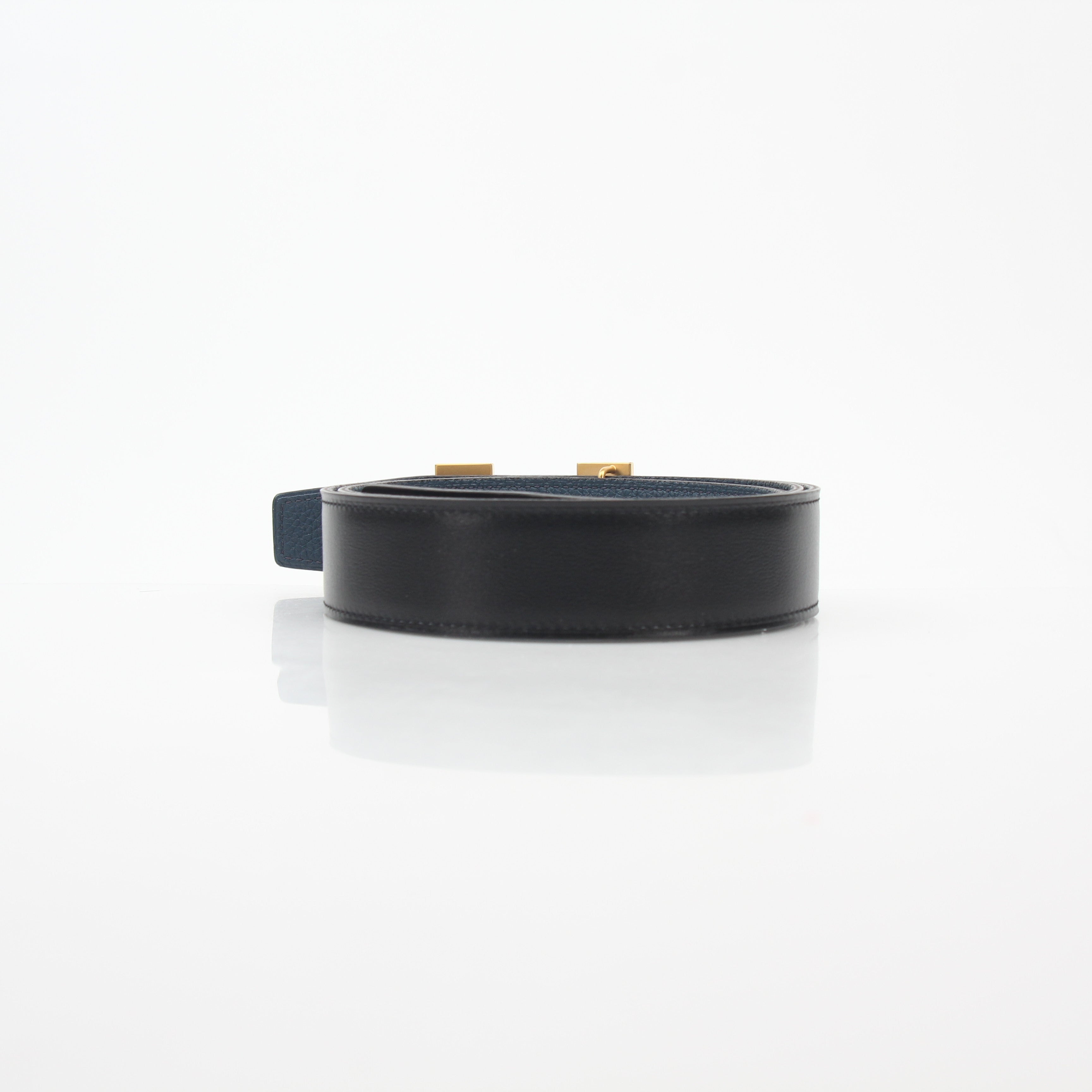 Hermès black and blue reversible belt by Gold & Beyond, showing the H buckle and adjustable strap details.