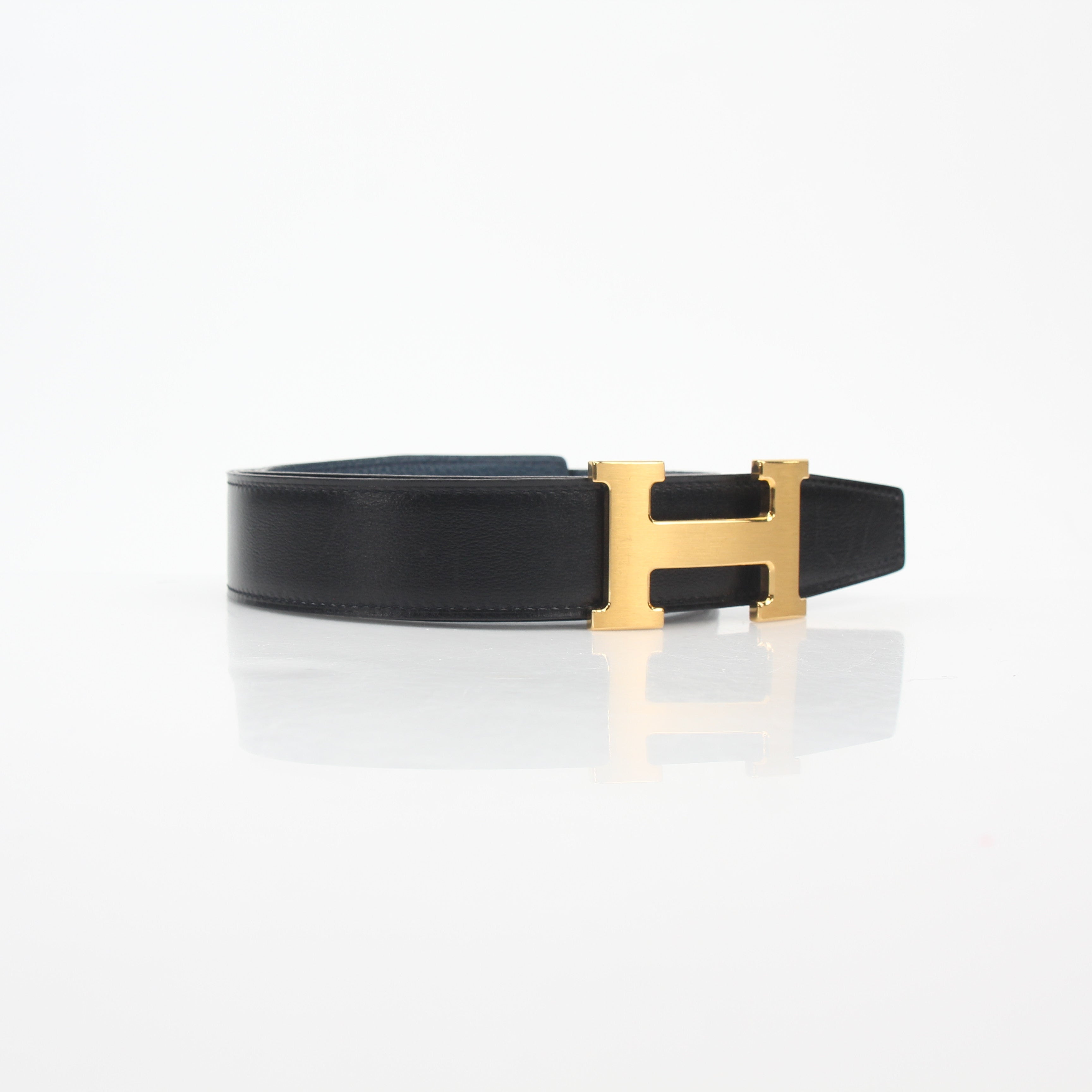 Hermès black and blue reversible belt kit with H buckle, designed for accessories and high-end fashion.