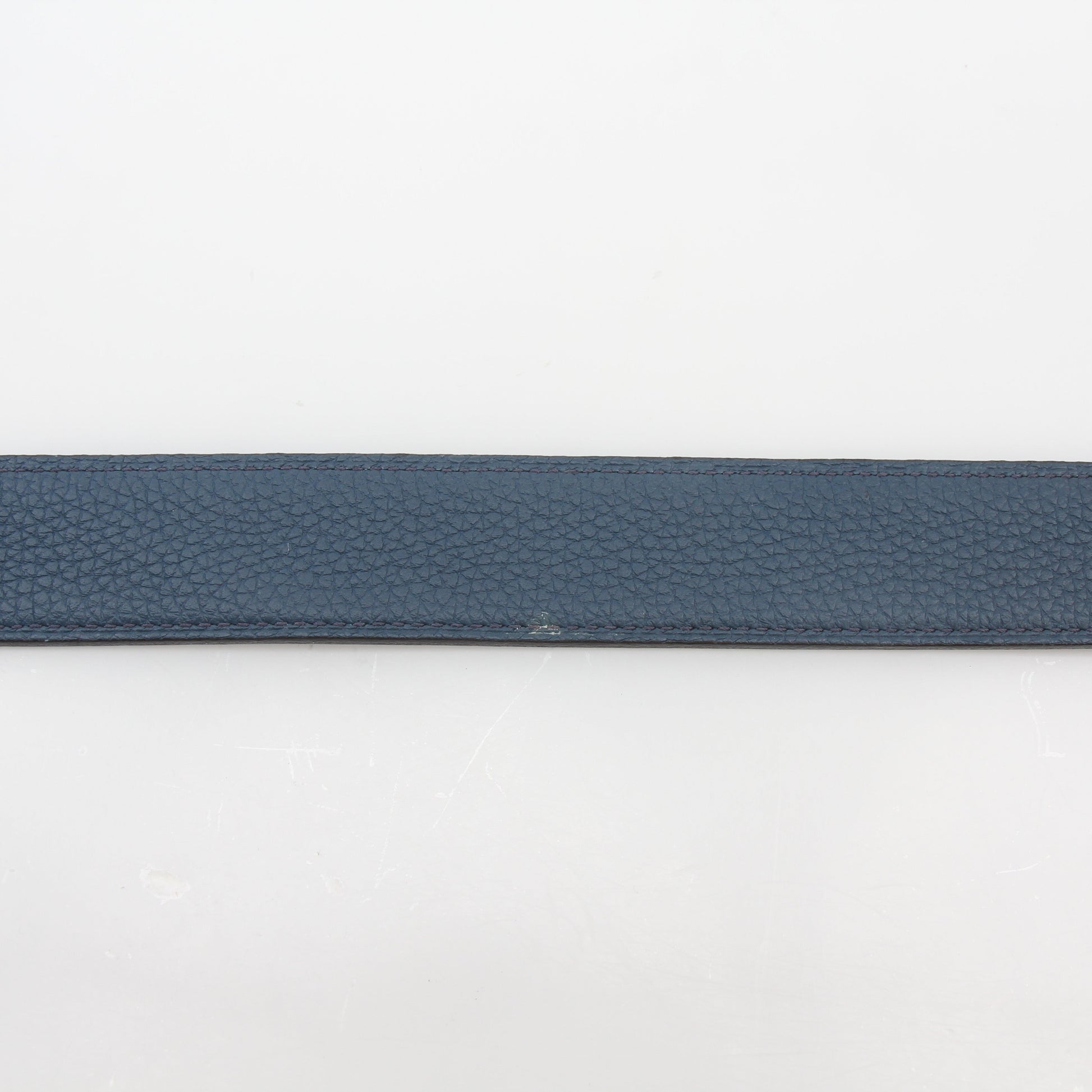 Hermès black and blue reversible belt kit with H buckle, showcasing stylish accessories from Gold & Beyond.