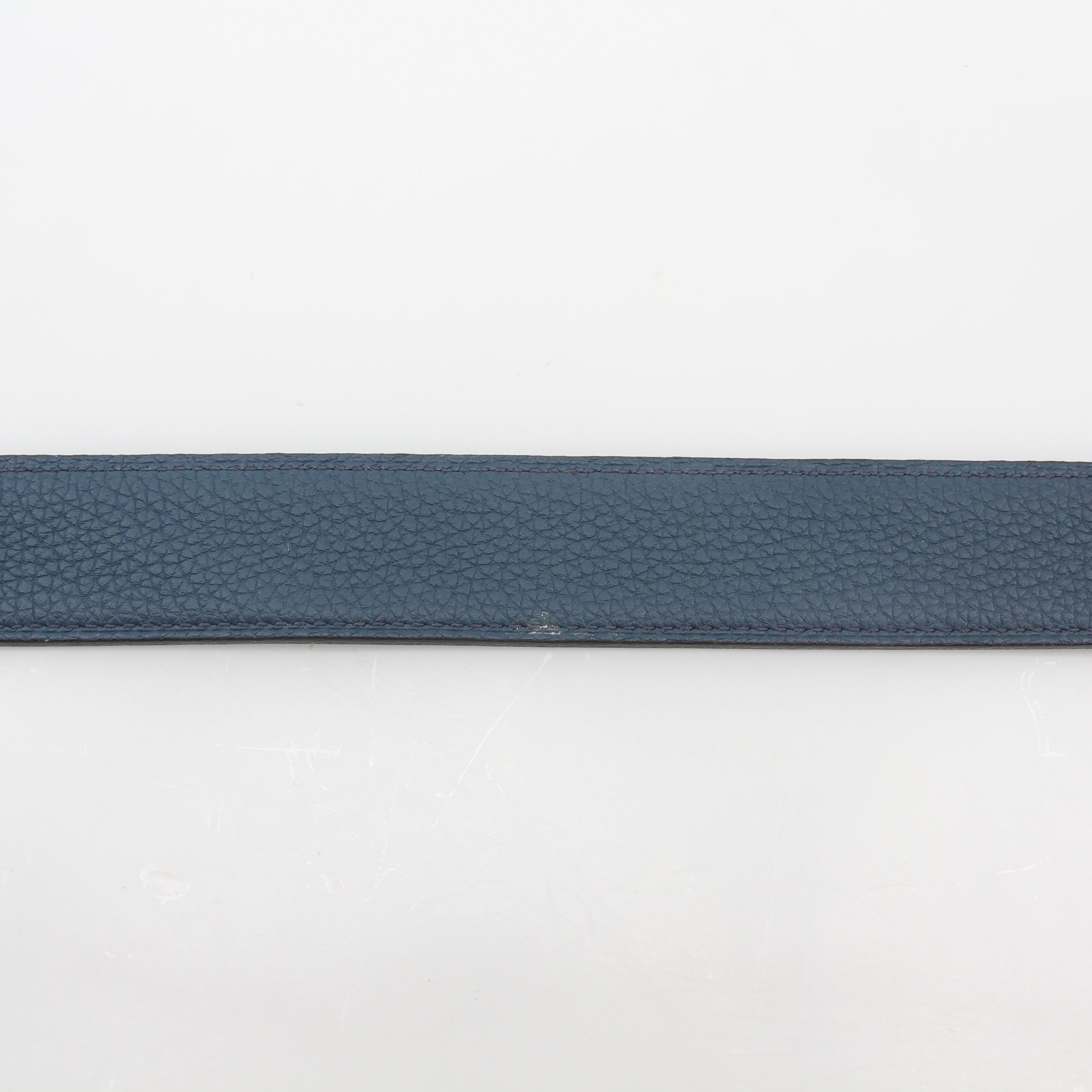 Hermès black and blue reversible belt kit with H buckle, showcasing stylish accessories from Gold & Beyond.