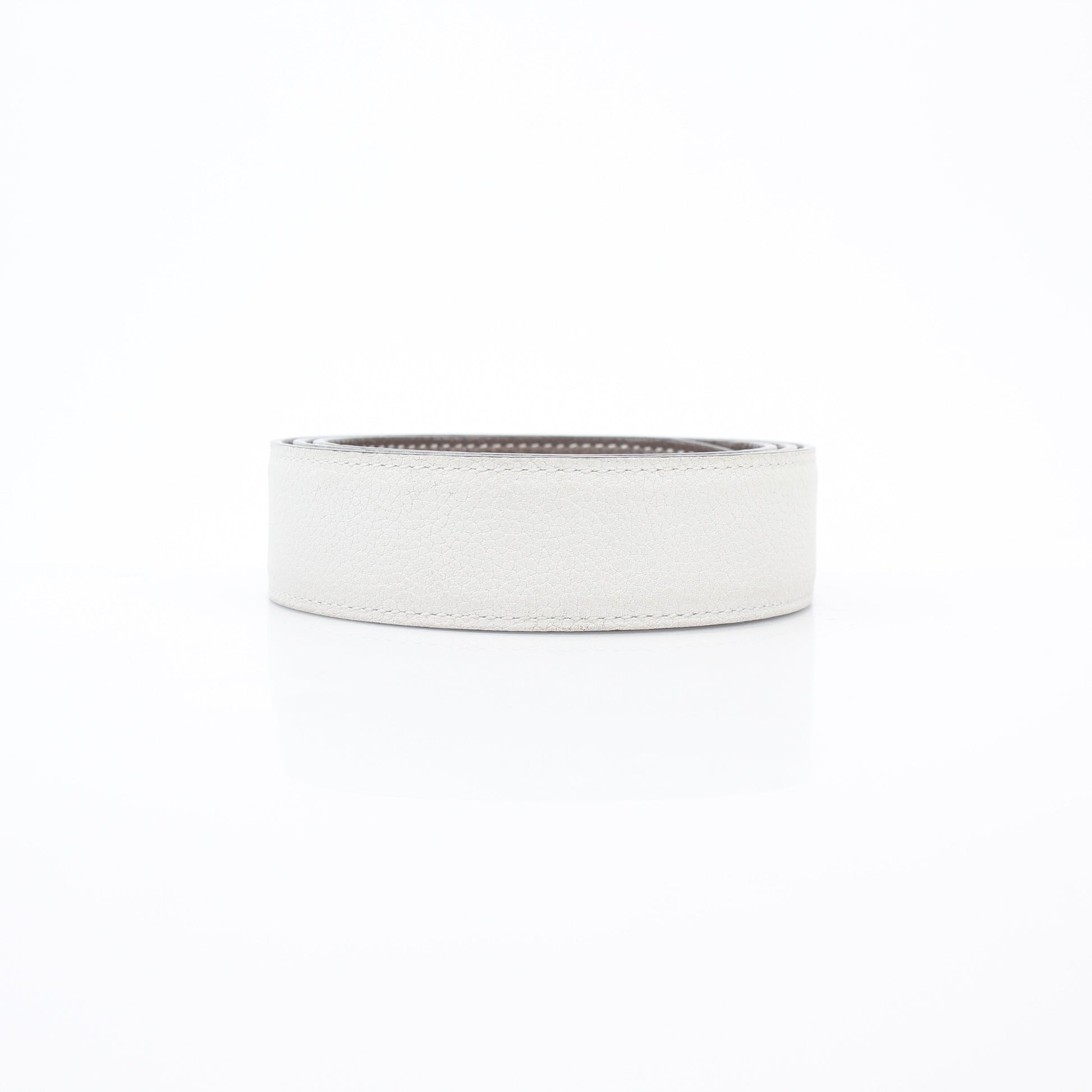 Hermès white and Etoupe reversible leather belt strap for accessories, showing the smooth leather surface and reversible design.