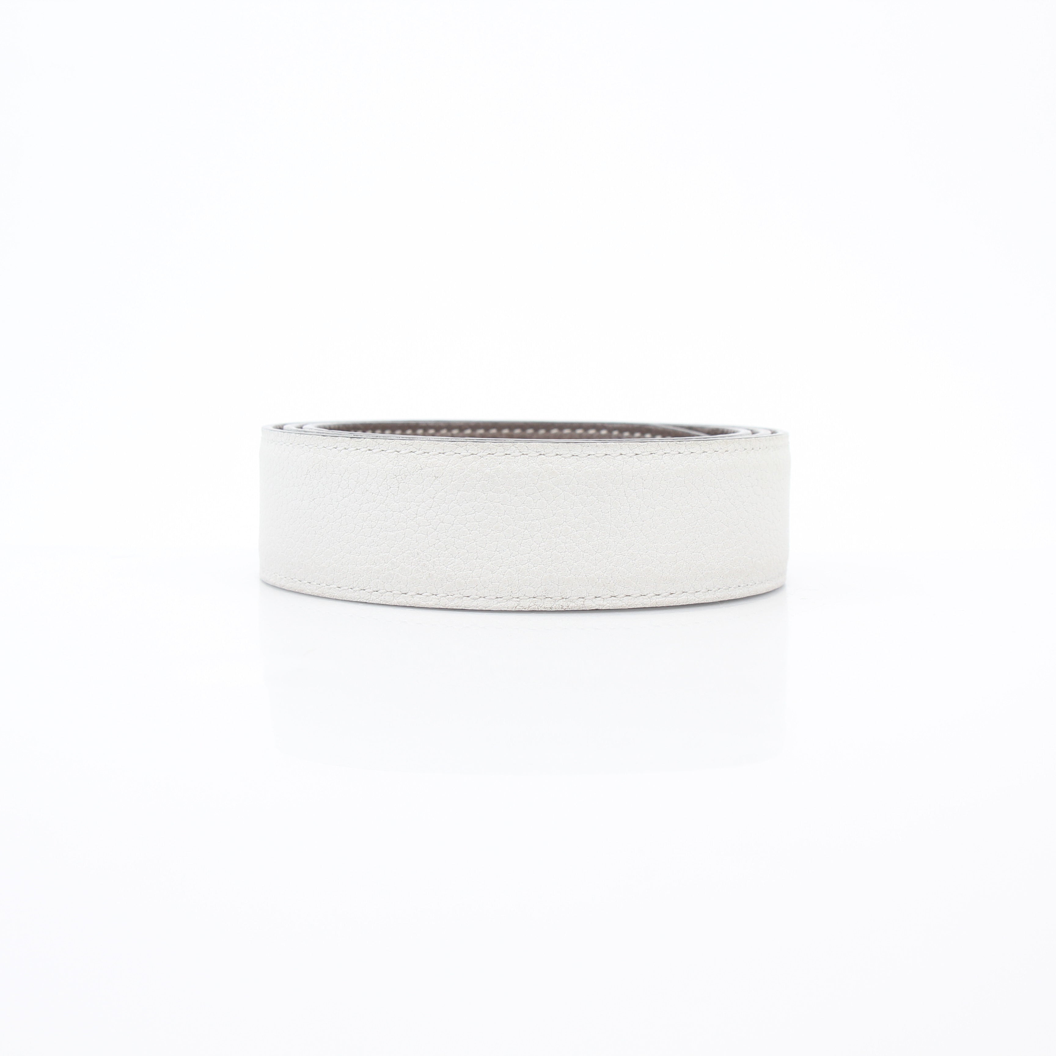 Hermès white and Etoupe reversible leather belt strap for accessories, showing the smooth leather surface and reversible design.