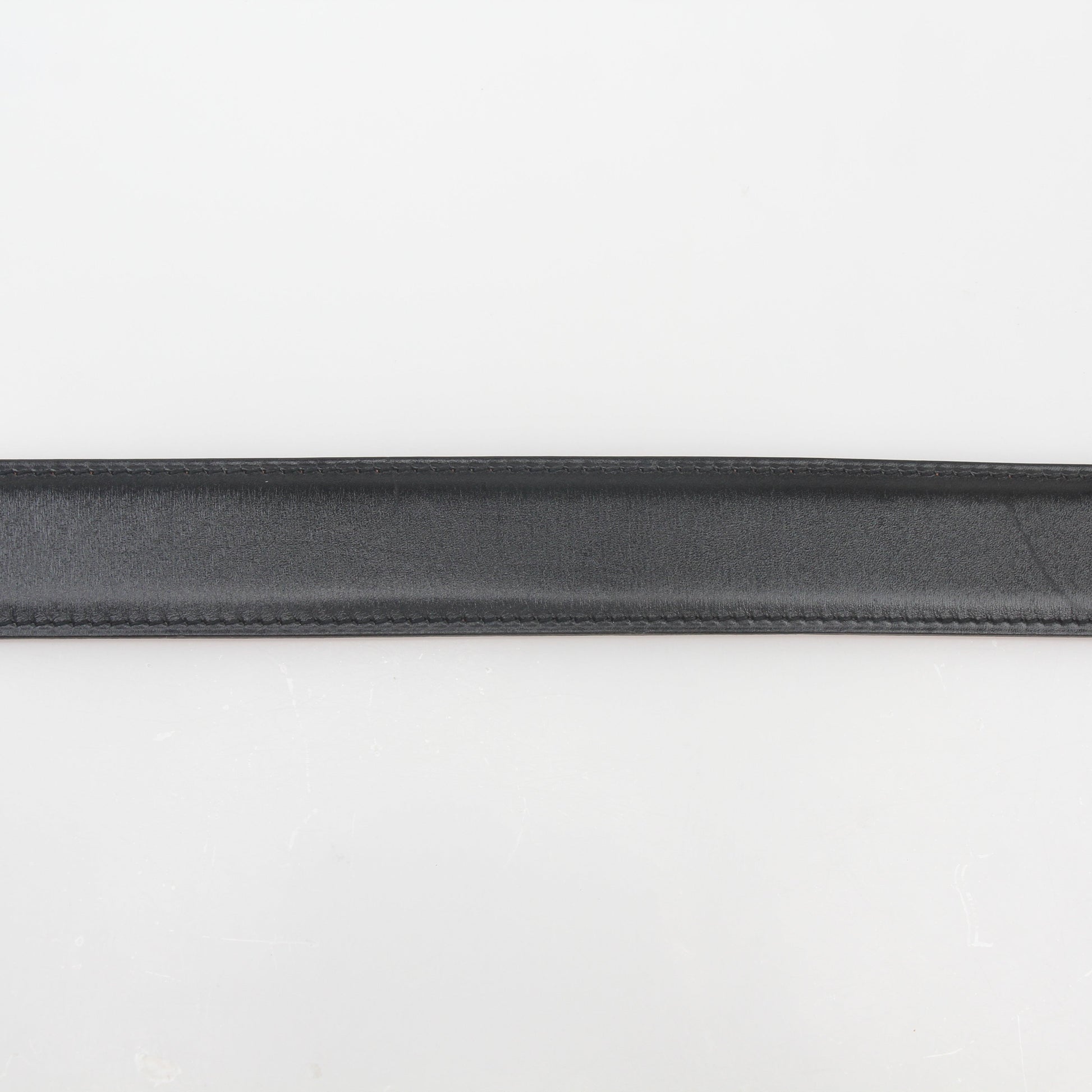 Hermès black and orange H reversible belt kit with gold accents, featuring adjustable straps and classic design.