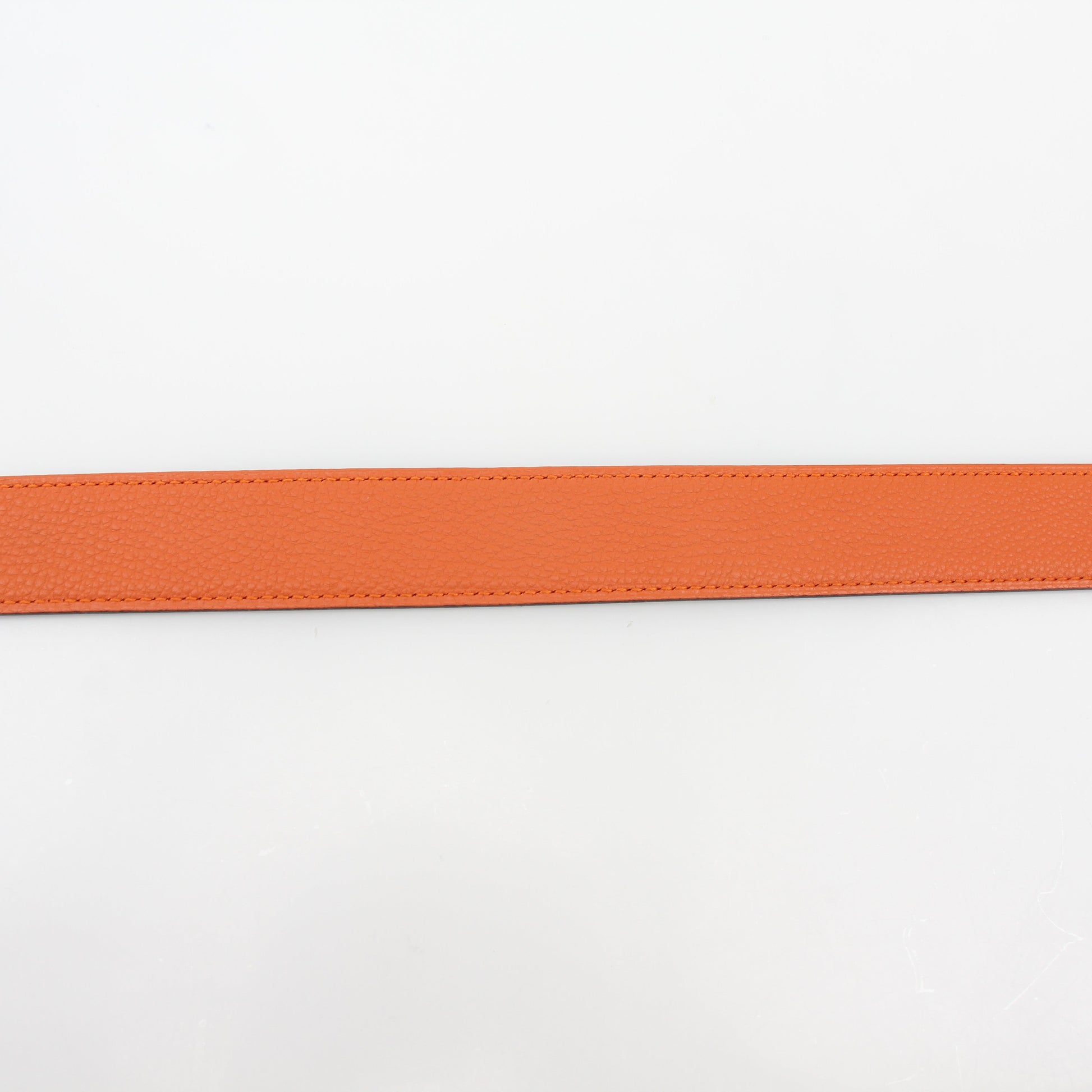 Hermès black and orange reversible belt kit by Gold & Beyond, showing the stylish belt with reversible H buckle and accessories.