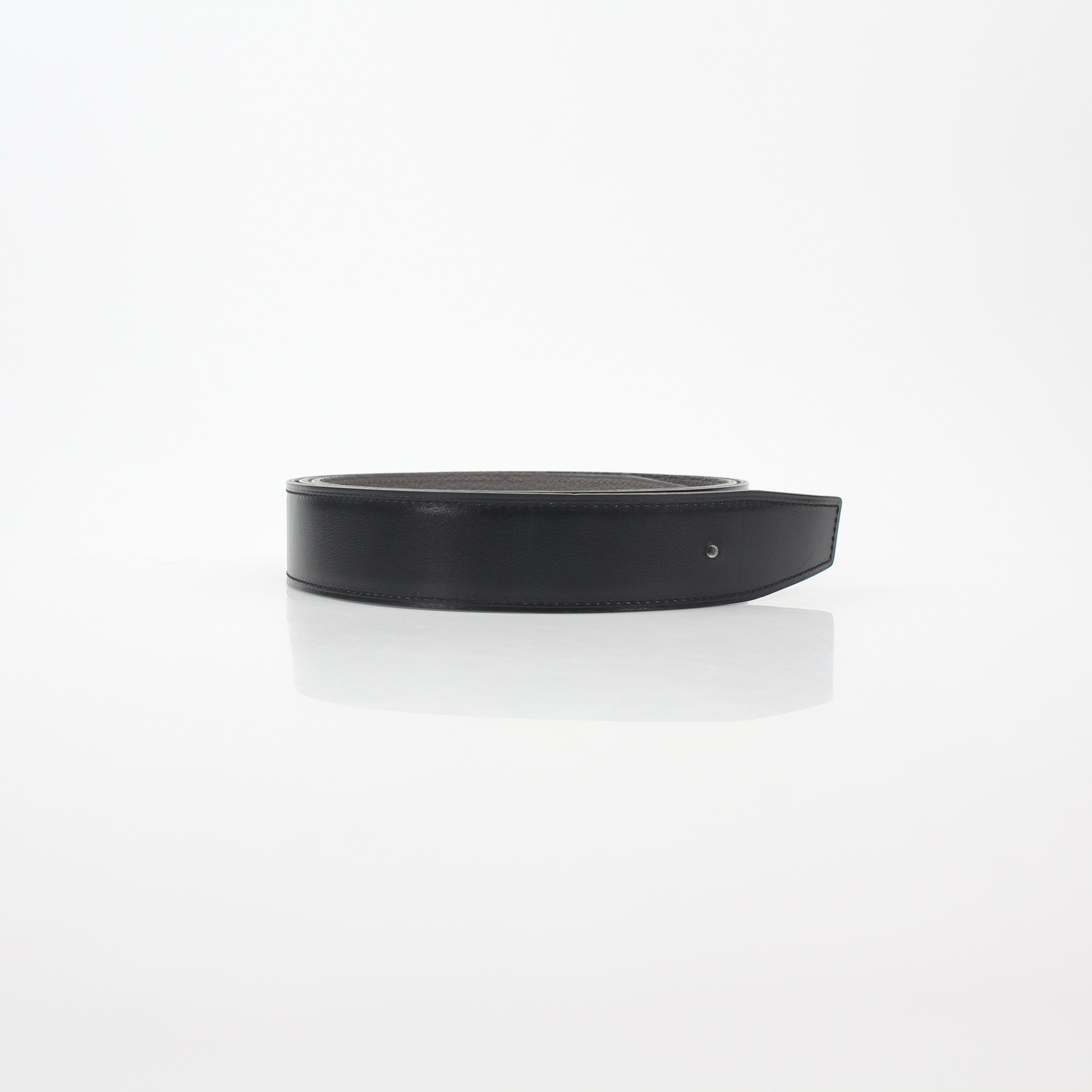 Hermès black and etoupe reversible leather belt strap for accessories by Gold & Beyond, showing textured leather and reversible design.
