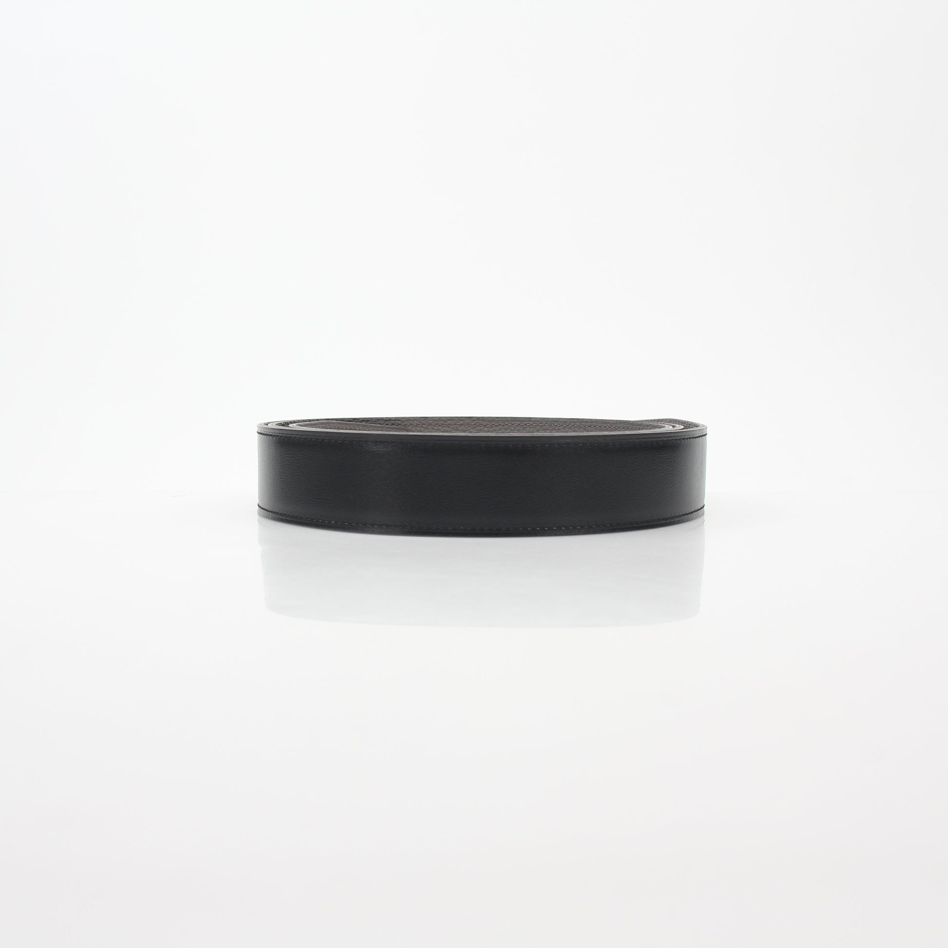 Hermès black and Etoupe reversible leather belt strap for accessories, featuring smooth leather and gold-tone hardware.