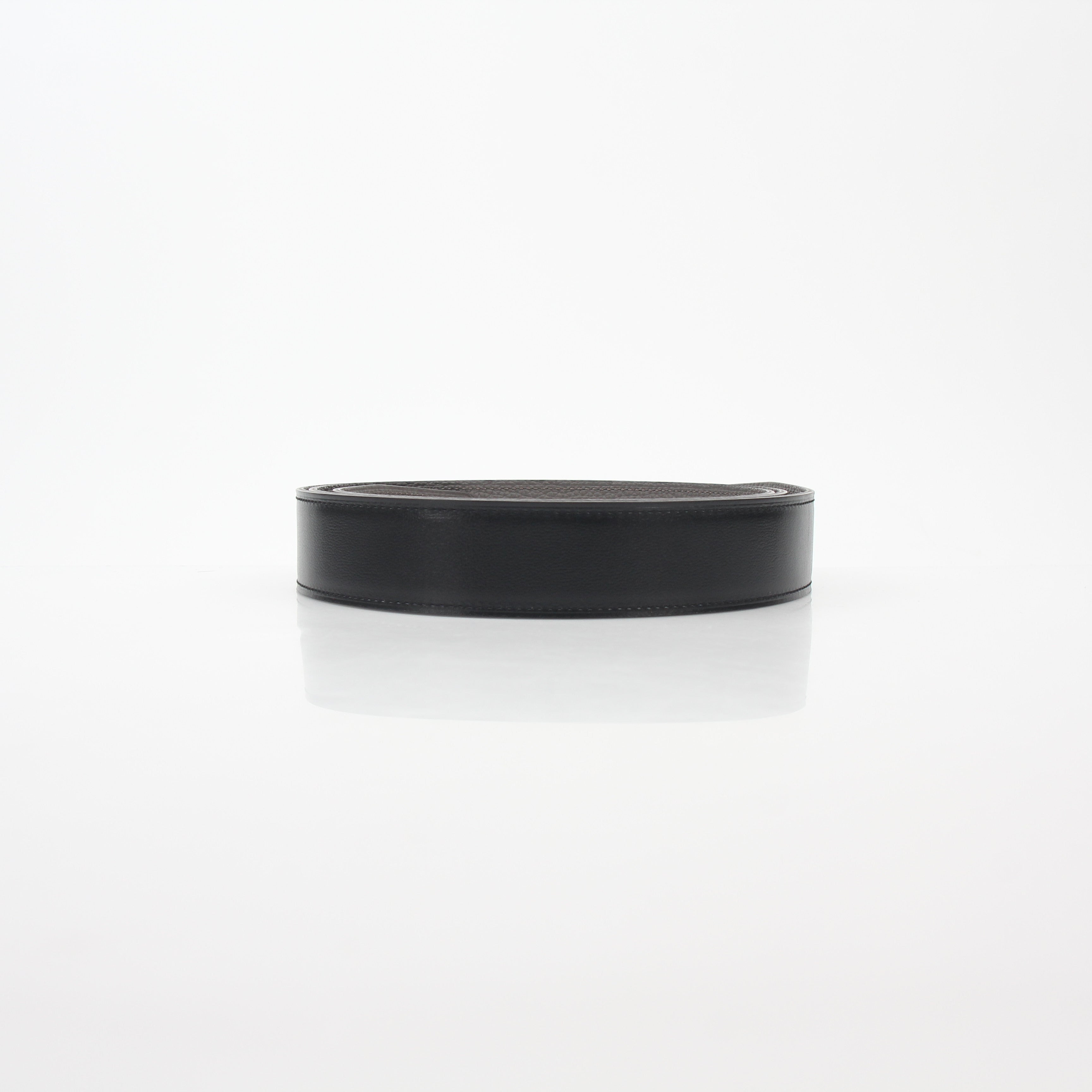 Hermès black and Etoupe reversible leather belt strap for accessories, featuring smooth leather and gold-tone hardware.