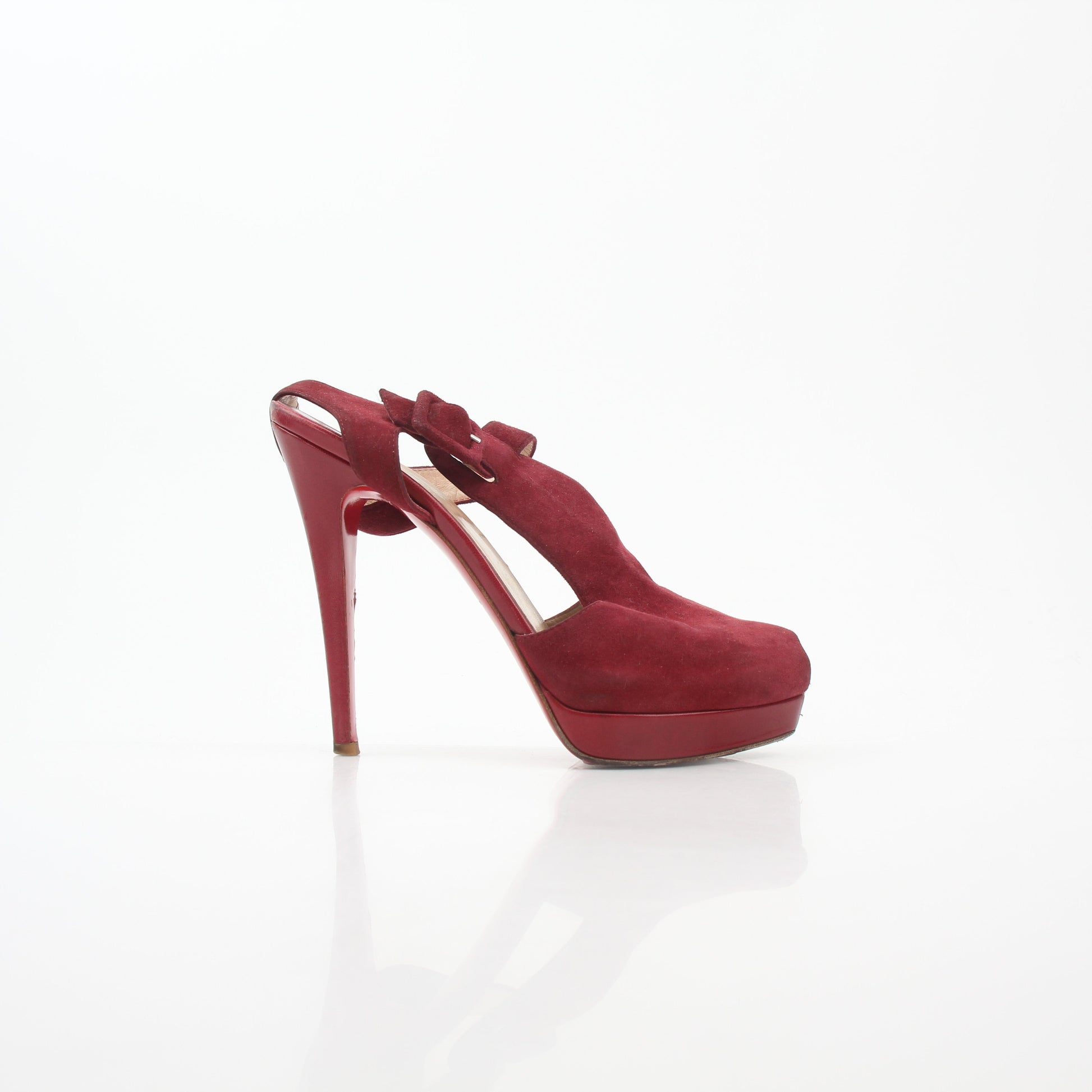 Christian Louboutin Red Orlan 140 suede T-strap heels with stiletto heel and elegant design, worn on a model.