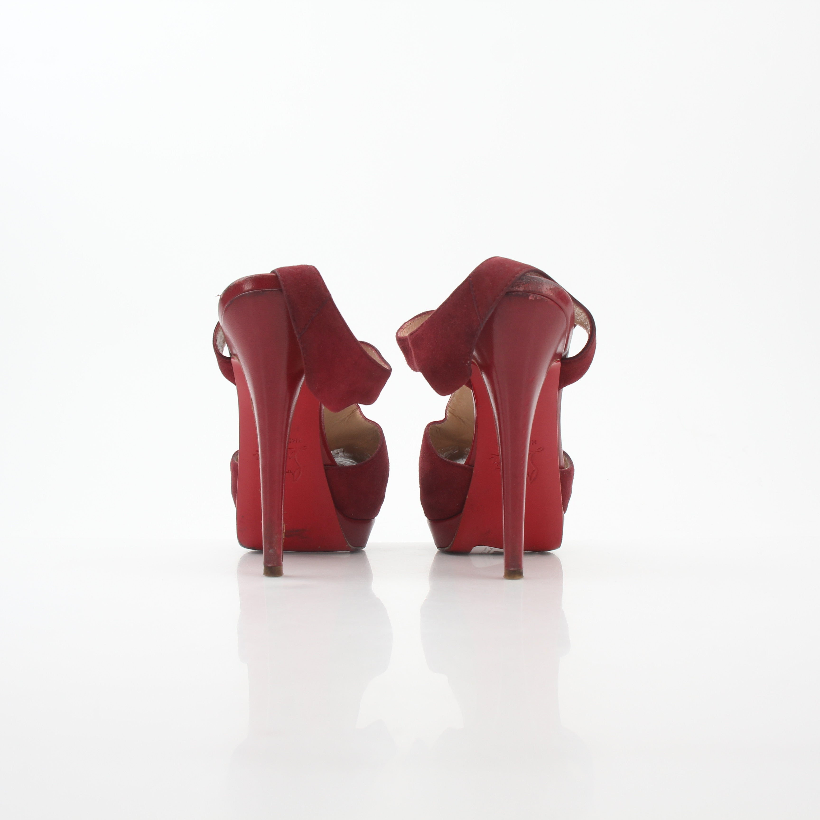 Christian Louboutin Red Orlan 140 suede T-strap heels with pointed toes and stiletto heels, displayed on a white background.