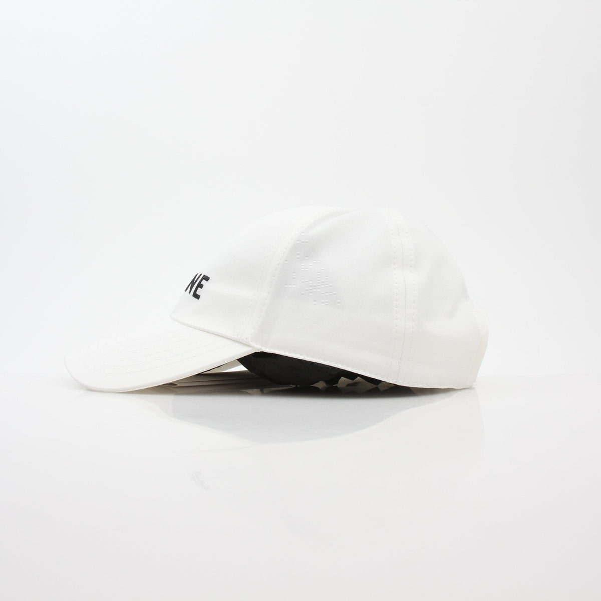 White cotton baseball cap from Celine, stylish accessories by Gold & Beyond, showing front view with adjustable strap