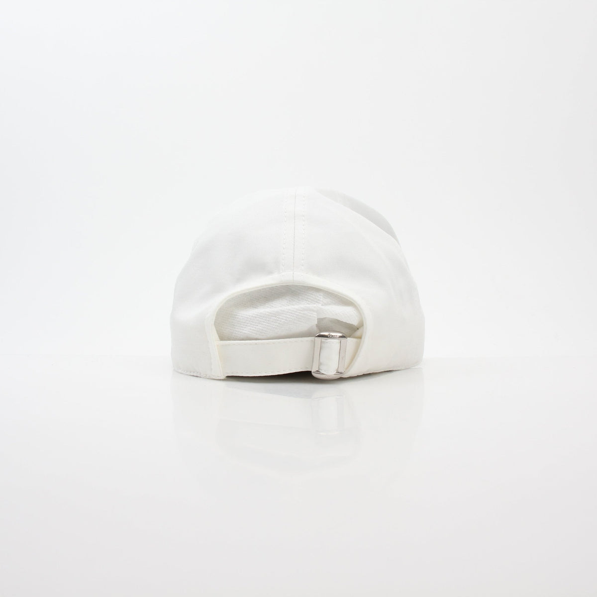 White cotton baseball cap by Celine, stylish accessory with curved brim and adjustable strap, branded by Gold & Beyond.