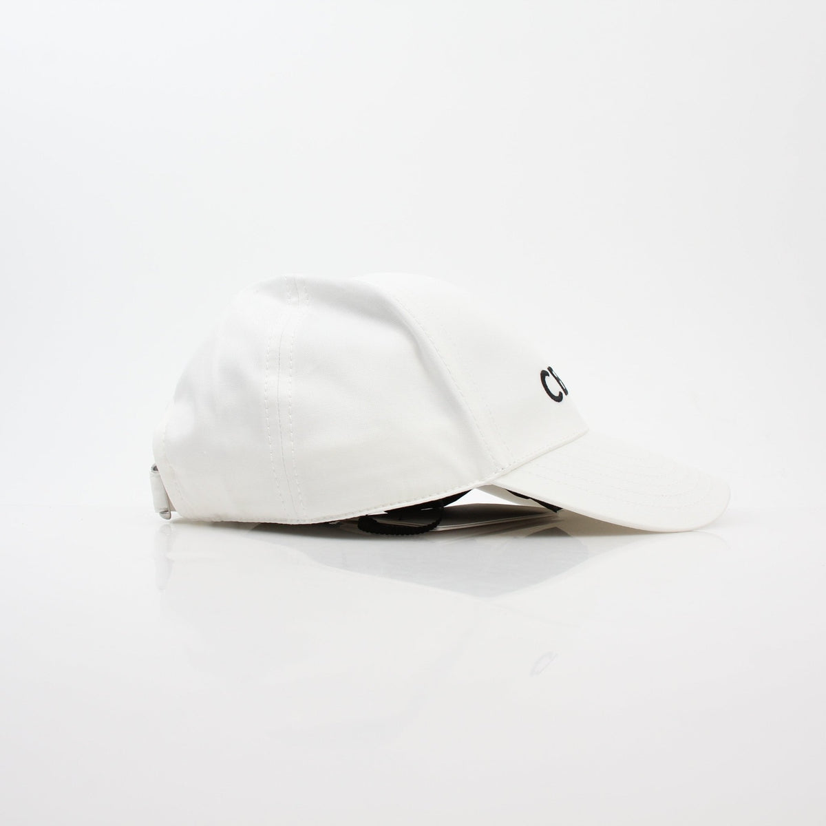 White cotton baseball cap by Gold & Beyond, Celine accessories, showing front view with structured brim and minimalist design.