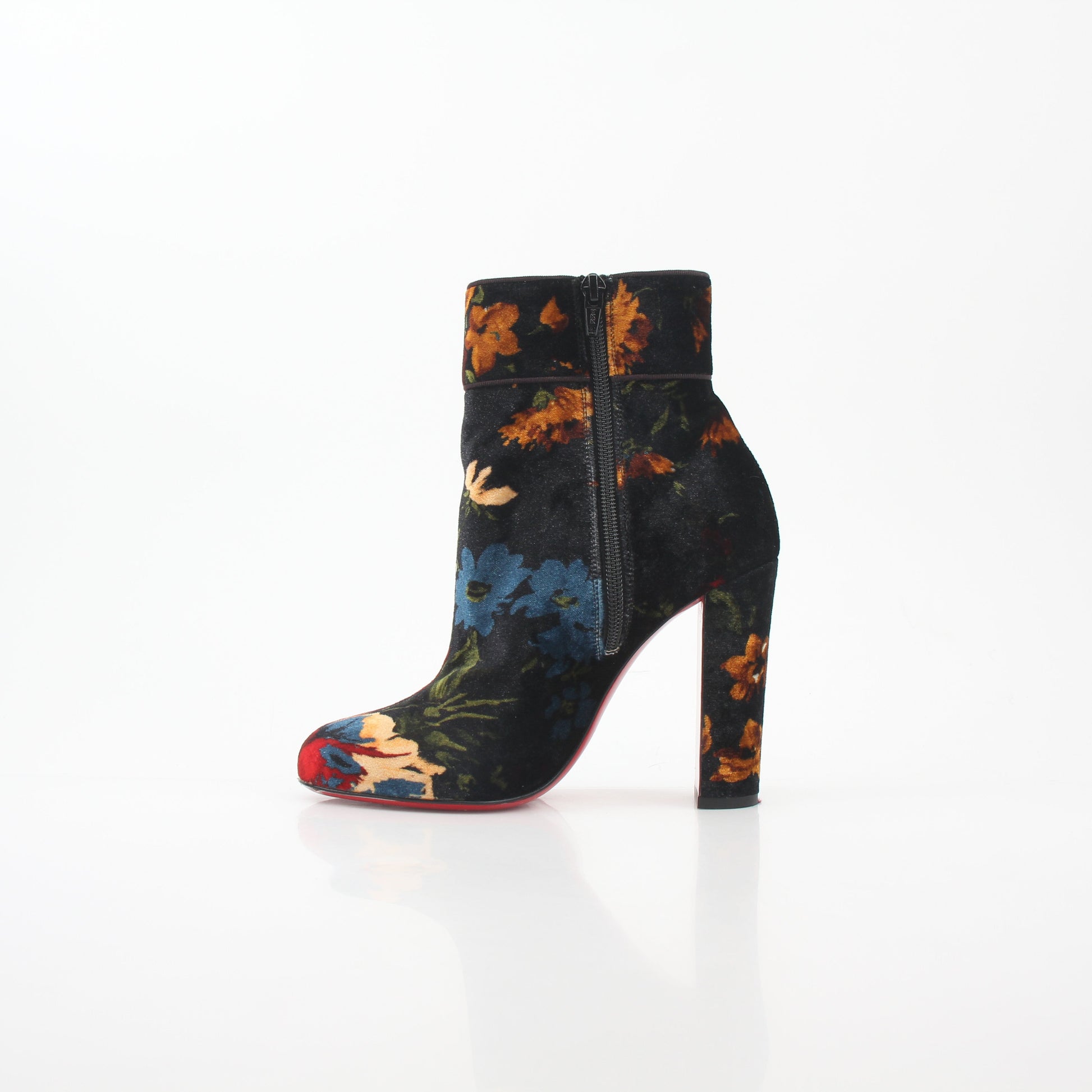Christian Louboutin Moulamax floral velvet ankle boots with vibrant flower patterns and sleek black soles.