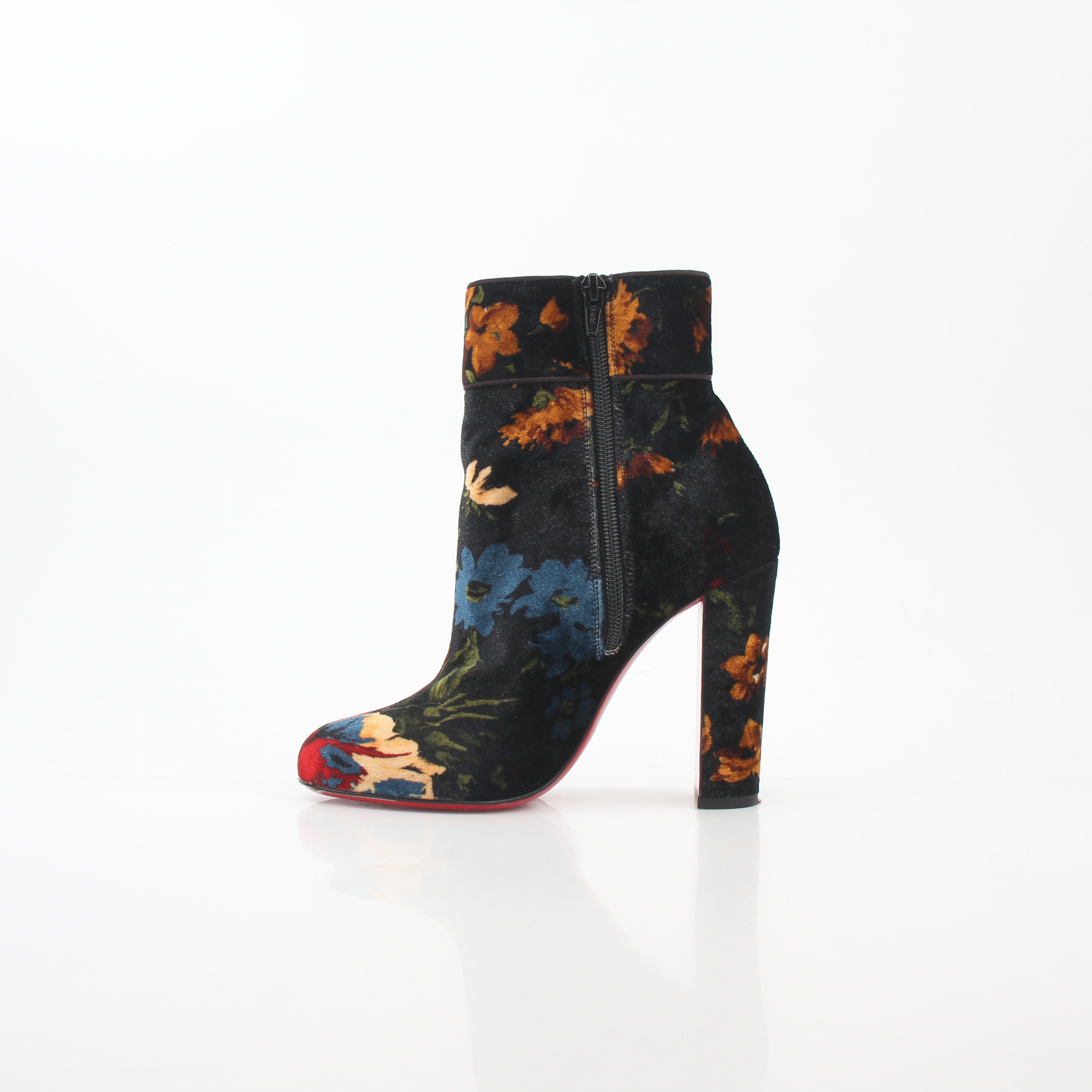 Christian Louboutin Moulamax floral velvet ankle boots with vibrant flower patterns and sleek black soles.