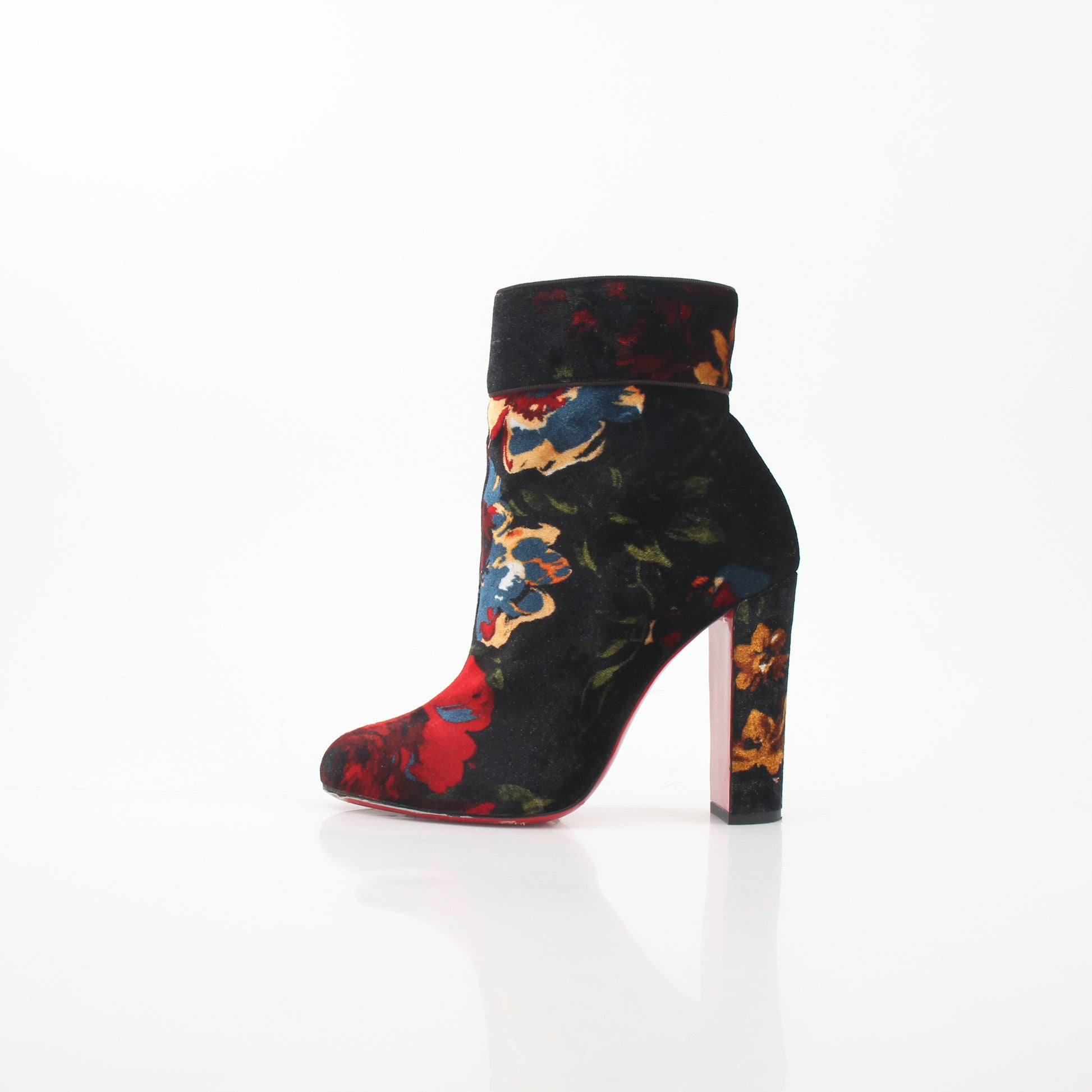 Christian Louboutin Moulamax floral velvet ankle boots with intricate floral patterns and sleek black soles.