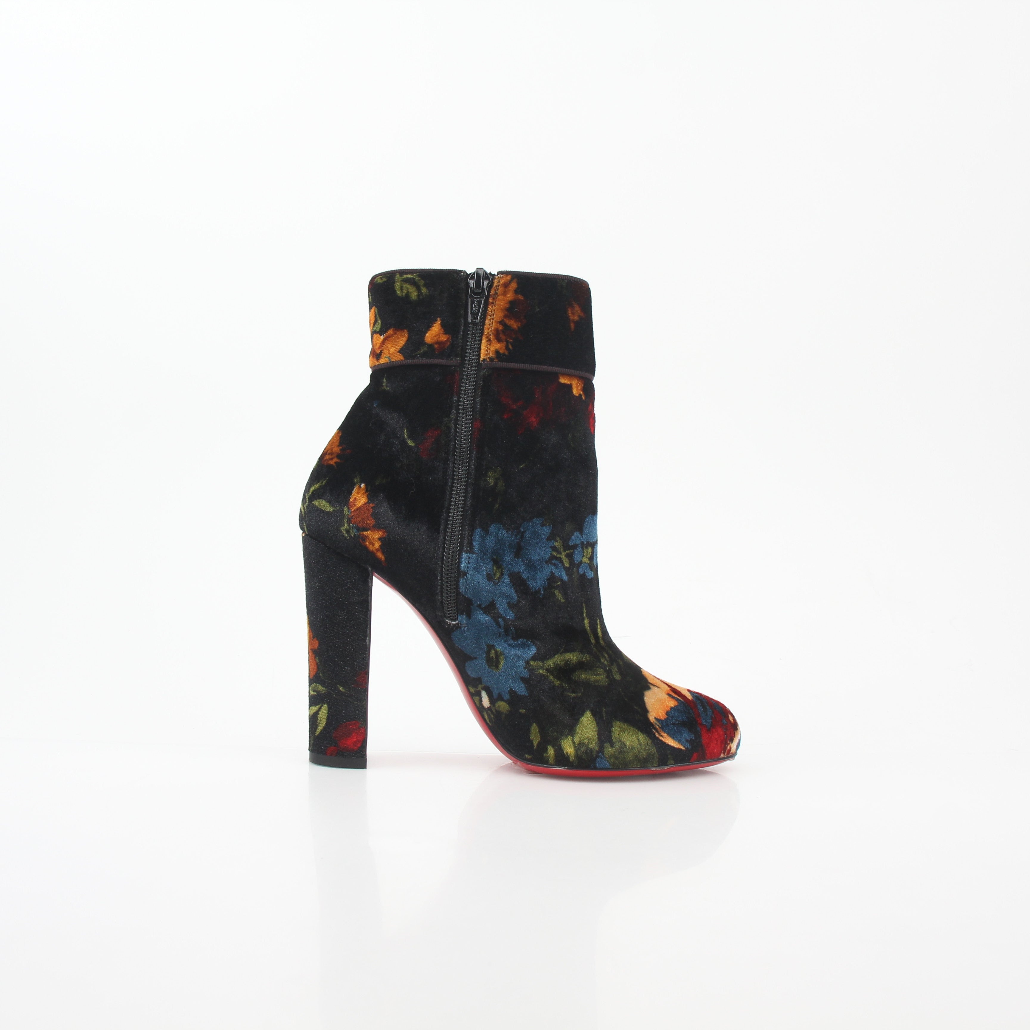 Christian Louboutin Moulamax floral velvet ankle boots featuring vibrant floral patterns and elegant shoe design.