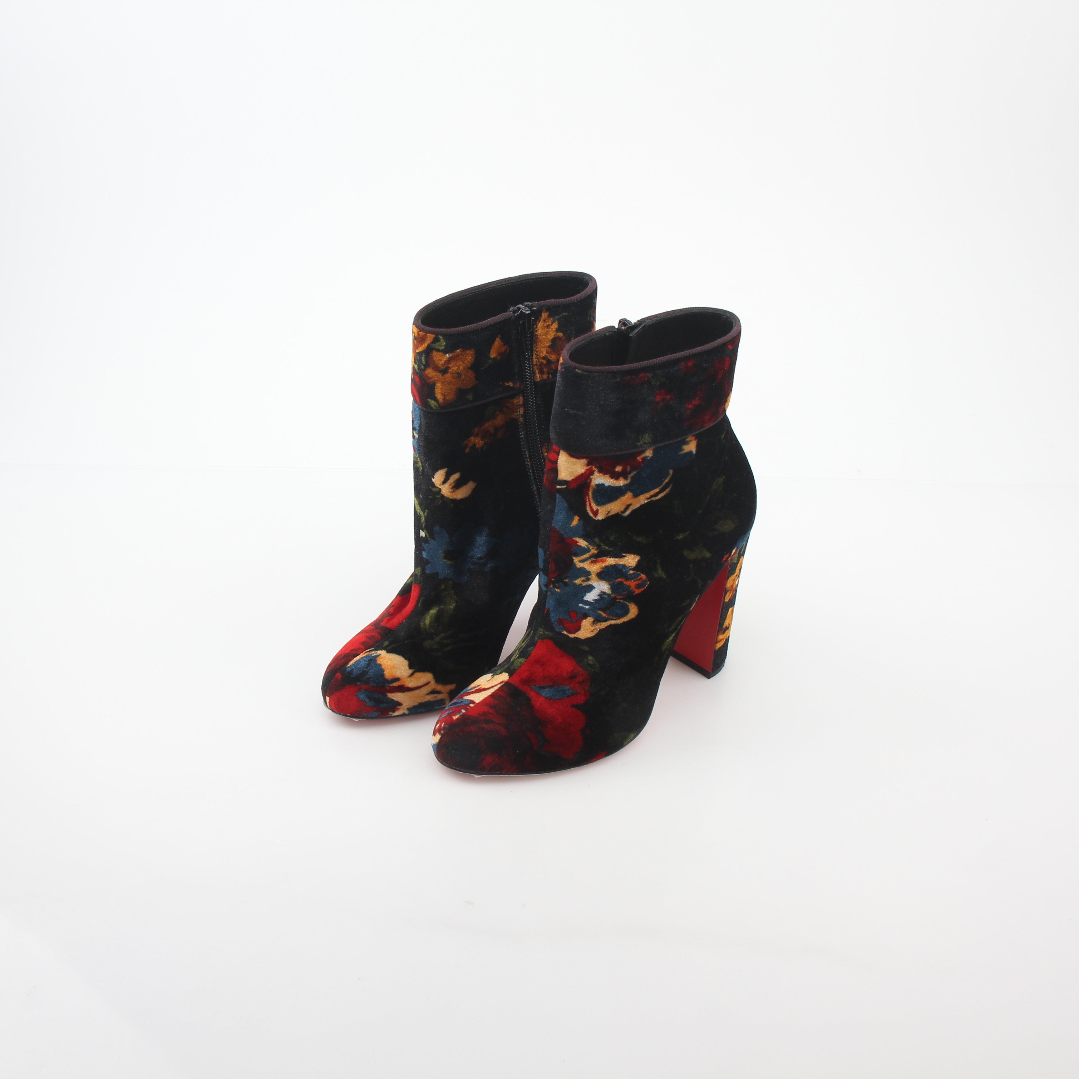 Christian Louboutin Moulamax floral velvet ankle boots with vibrant floral embroidery and sleek black heels.