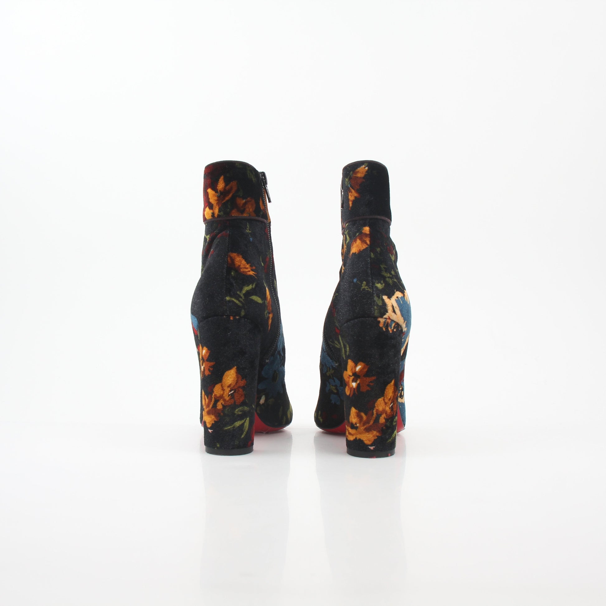 Christian Louboutin Moulamax floral velvet ankle boots with red soles, featuring a stylish floral design and pointed toe.