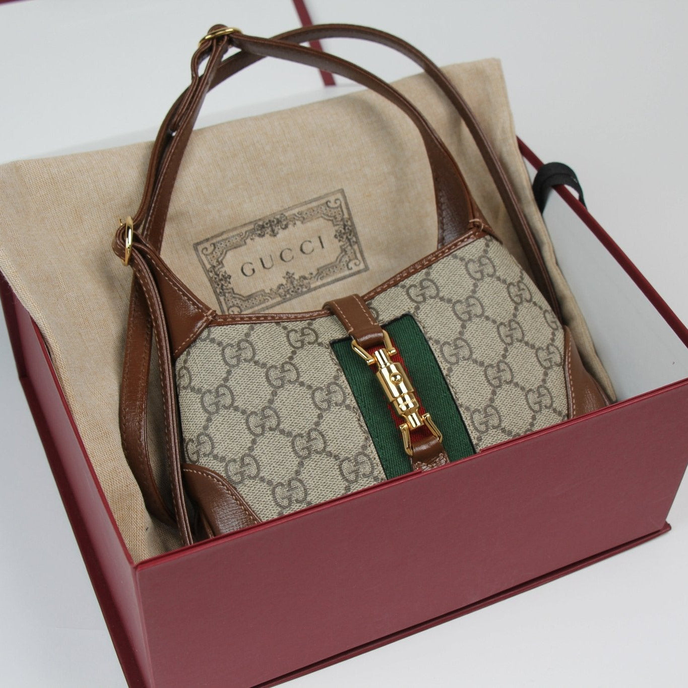 Gucci Jackie 1961 Mini Handbag in beige with brown leather trim and gold hardware, featuring signature design elements.