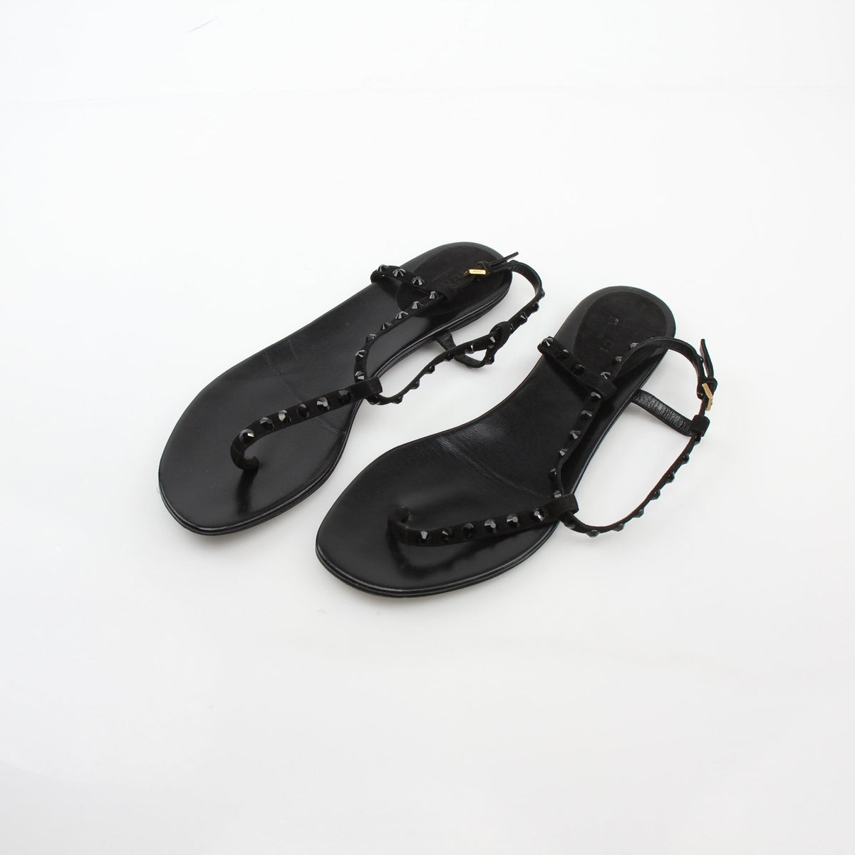 Gold & Beyond Gucci black crystal-embellished T-strap flat sandals, showcasing elegant T-strap design and sparkling crystal details.