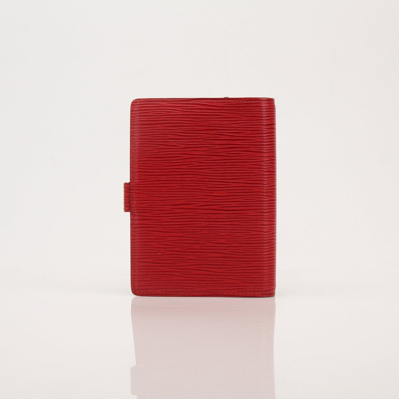 Louis Vuitton Epi Agenda Planner accessory with textured leather cover and gold details, designed for organizing and note-taking.