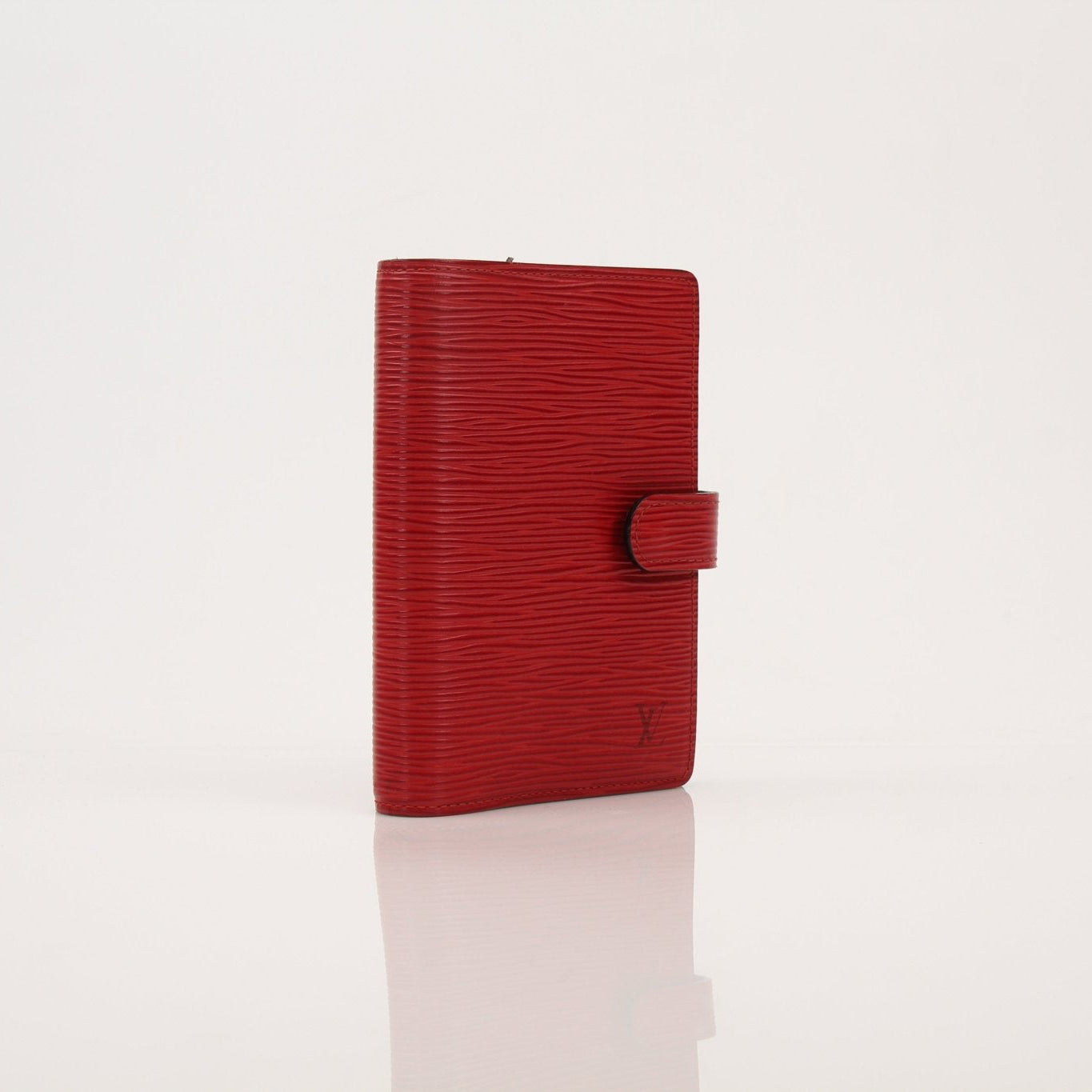 Louis Vuitton Epi Agenda Planner in textured leather with gold accents, showcasing its compact, stylish accessories design.