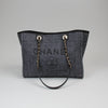Chanel Deauville Tweed Tote in beige and black, featuring woven texture and structured design with dual handles.