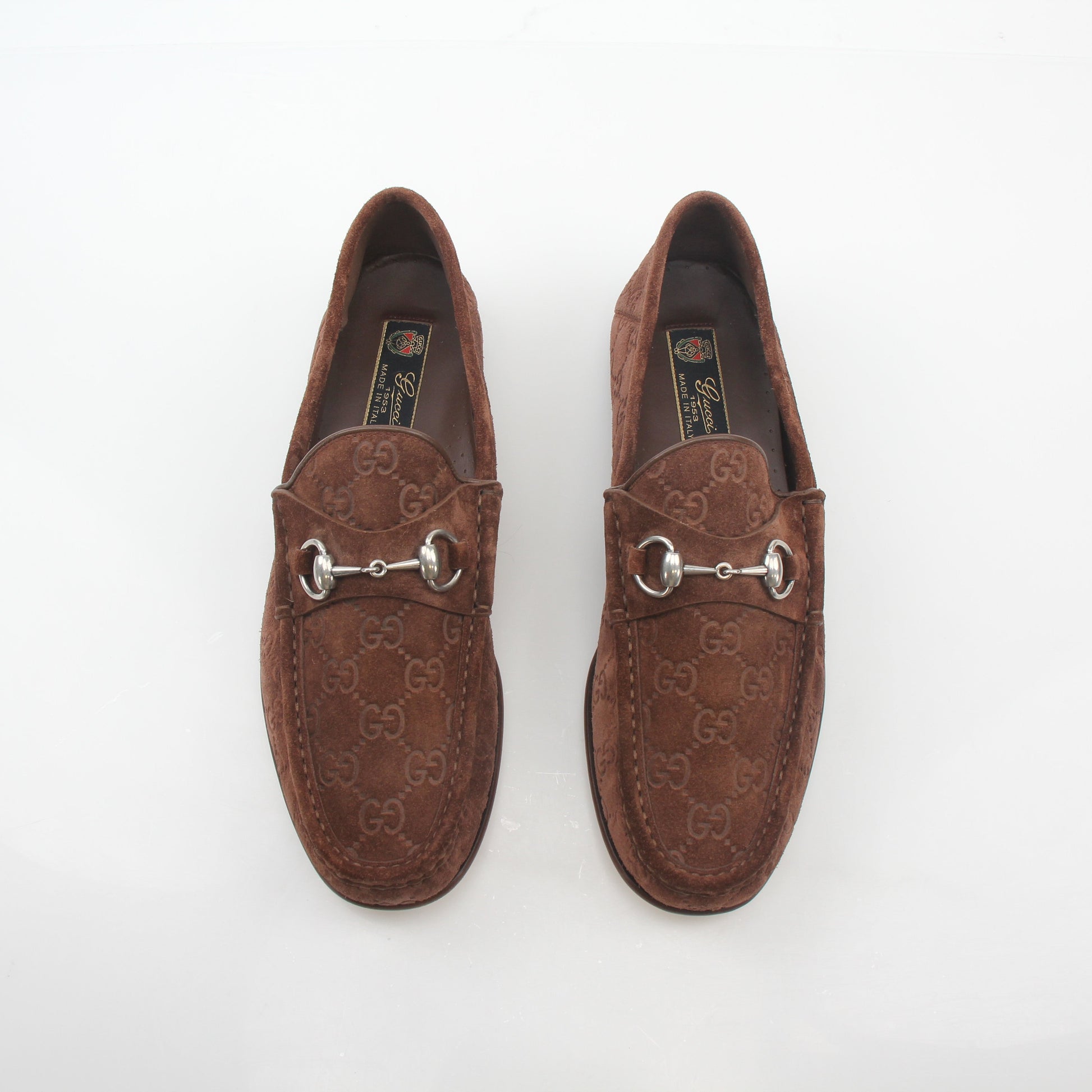 Gucci brown GG suede Horsebit 1953 loafers, stylish shoes with gold accents, displayed on a neutral background.