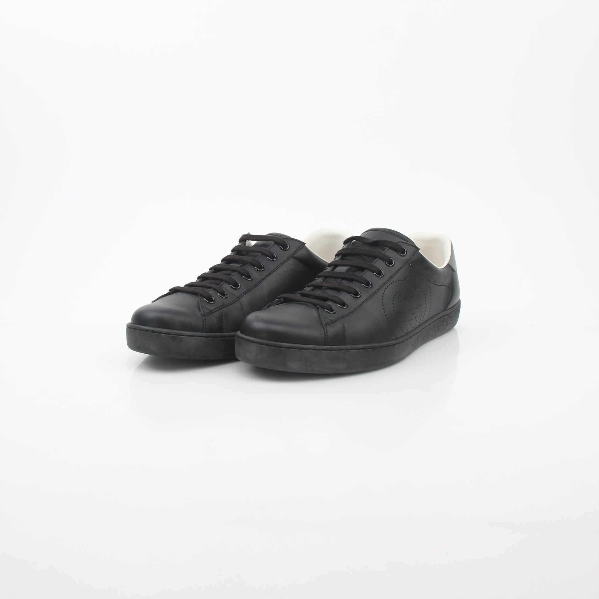 Gold & Beyond Gucci black leather Brooklyn low-top sneakers with sleek design and classic lace-up style.